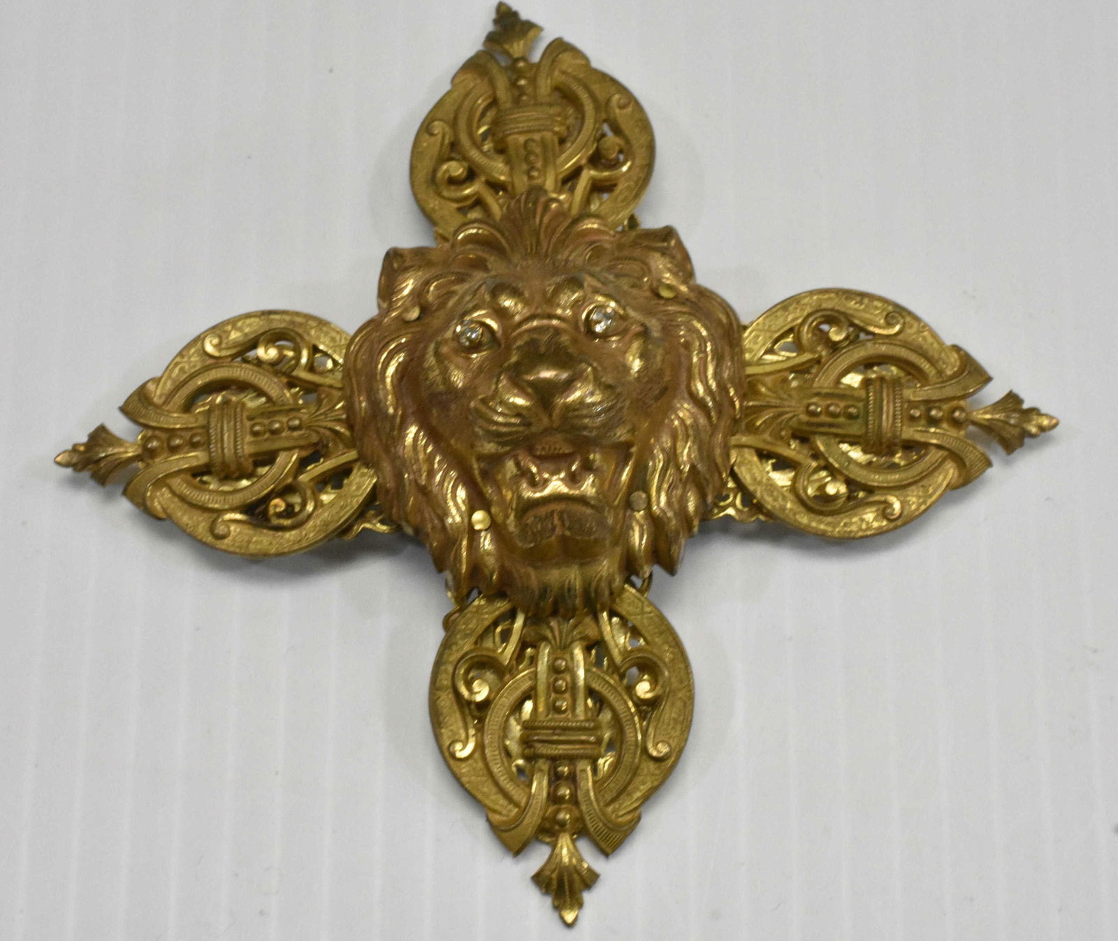 Massive Miriam Haskell Lion Head Brooch: Brooch is in the form of a Maltese cross having a lion's head with jeweled eyes. Measures approx. 4 1/2" across and has oval Miriam Haskell plate on back.