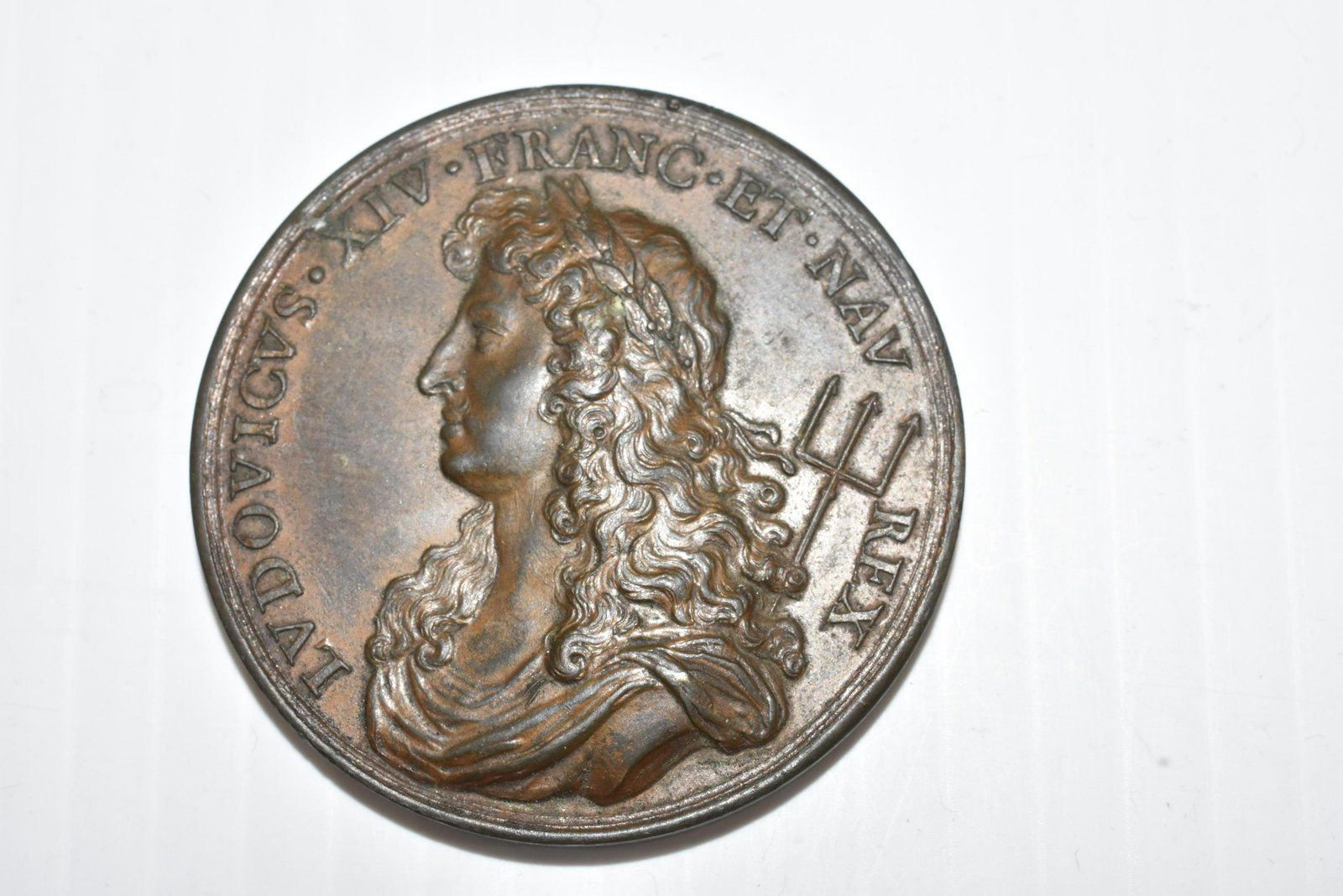 French Bronze Medal dated 1668: Face of coin depicts King Louis VI and reads "LVDOVICVS.FRANC. ET. NAV. REX. NAVIGATIO INSTAVRATO" on face. Reverse side depicts a three mast ship and acknowledges the strength of the Navy by the grac