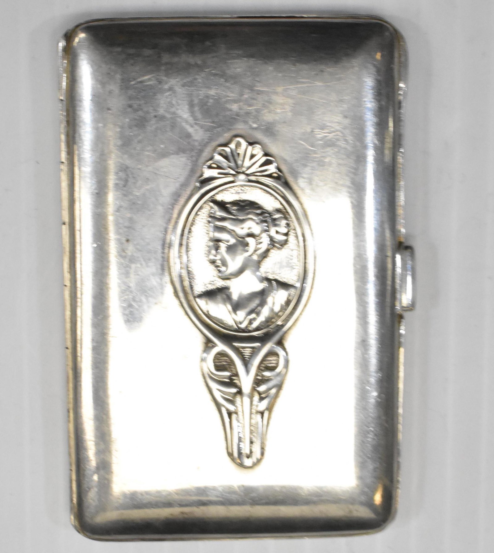 19th Century French Sterling Card Case: Measures approx. 3 1/4"h. It depicts a bust of a woman in a frame on the face and has a French sterling mark.