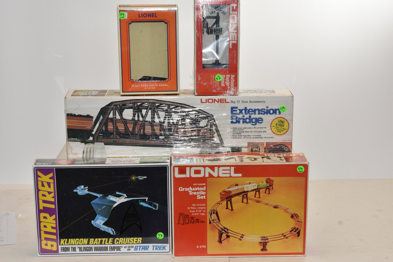 Grouping of Lionel O Gauge Accessories in Box: Including an extension bridge #6-2122, a Banjo signal #6-2140, a Banjo signal #6-14149, a graduated trestle set #5-2110 and a Star Trek Klingon battle cruiser in original shrink wrap.