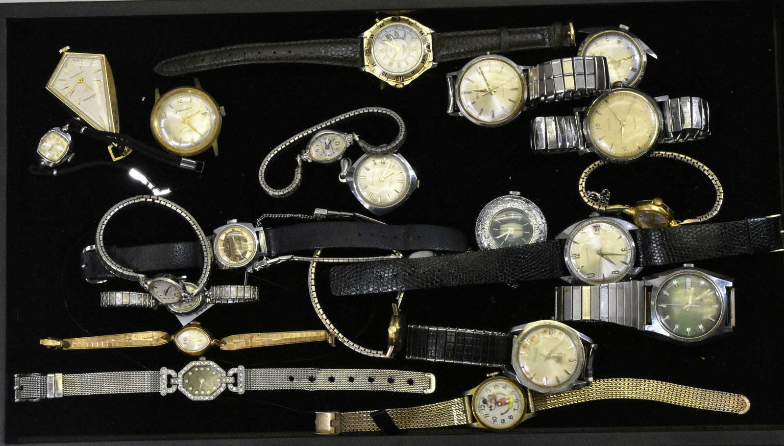 Collection of Vintage Watches: Includes a Mickey Mouse watch with a mesh band marked "Swiss Made", a men's Caravelle with day and date marked :"Swiss", a Gruen Precision marked "Swiss Made" and various men's Vantage watches. Lady's