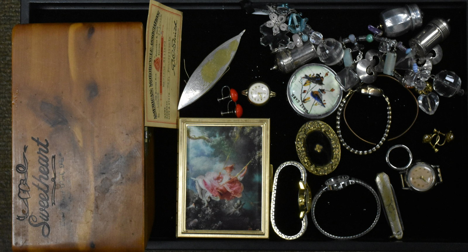 Eclectic Mixed Grouping: A charm bracelet with crystal and salt and pepper shakers, a pill box with an onyx stone, three lady's watches with bands, a lady's Easton watch marked "Swiss" with no band, a cedar jewelry box and mo