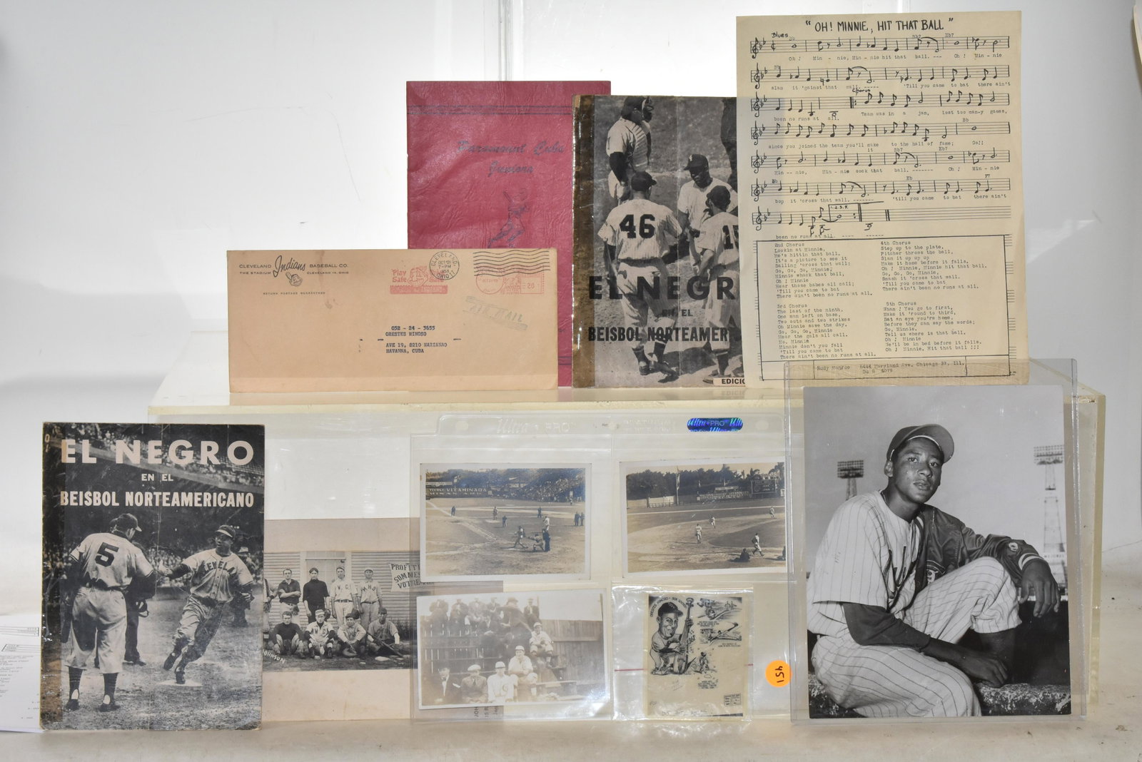Minnie Minoso Grouping and Negro League items: Includes Minnie Minoso song sheet music "Oh Minnie Hit that Ball", Christmas greeting post card from Cleveland Indians Club to Minnie, and small original art of Minnie cartoon. Plus 2 El Negro program