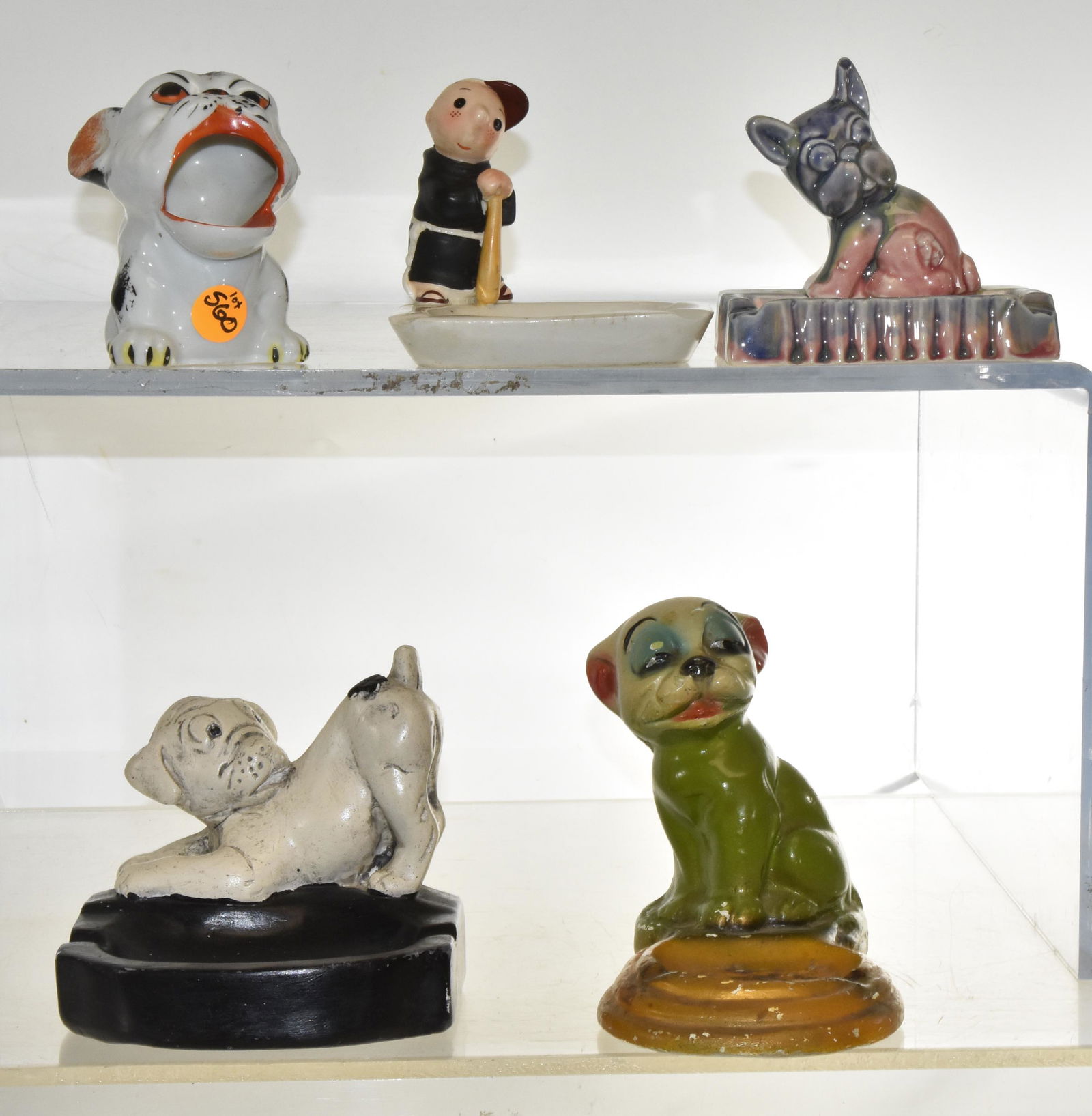 Collection of Vintage Ashtrays: Includes two chalkware dog ashtrays (possibly carnival prizes), a Brother Juniper 1958 porcelain ashtray, and 2 ceramic ashtrays. All from the first half of the 20th century. Largest measures 5 1/2" h