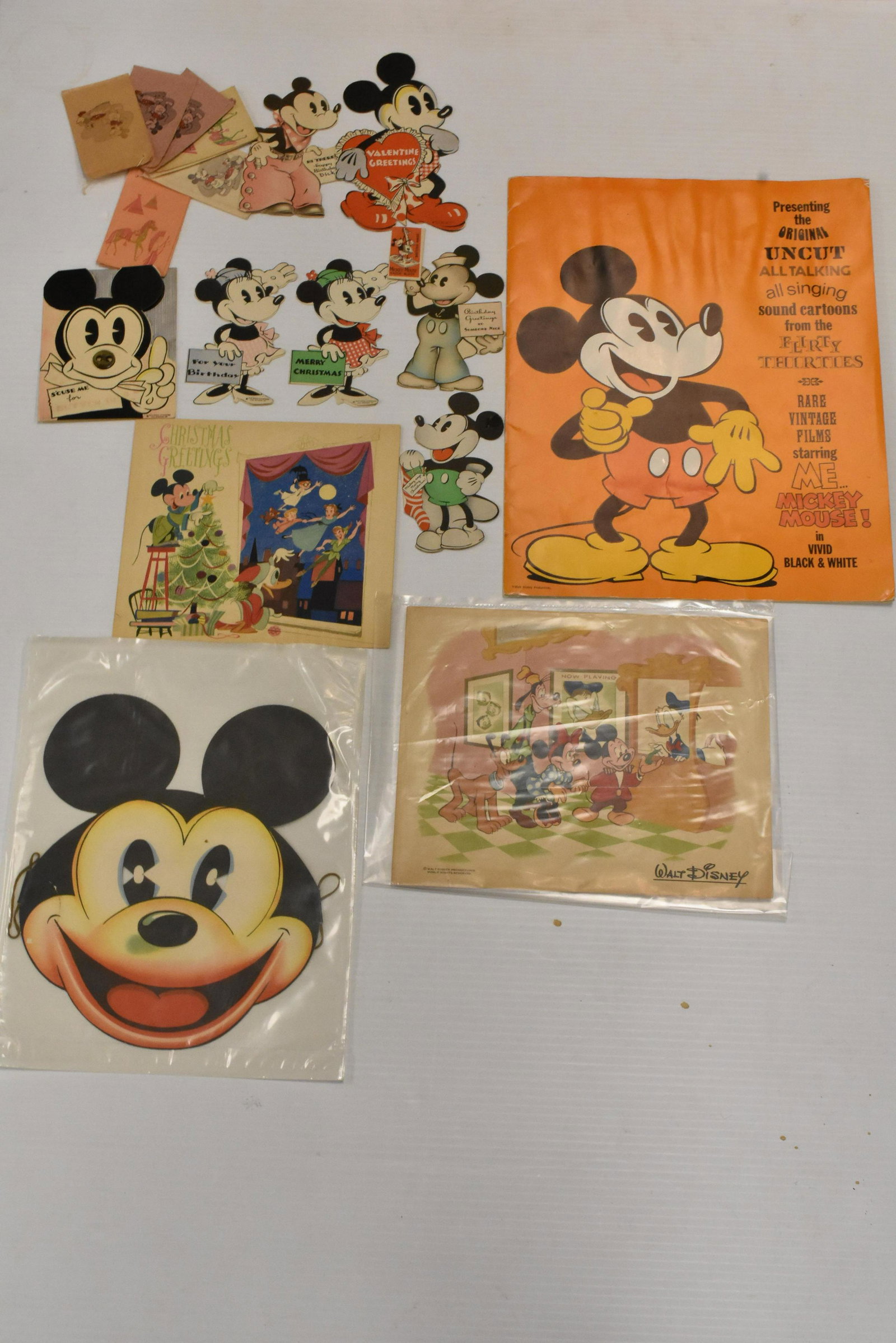 Mickey Mouse Ephemera: Six Mickey Mouse figural greeting cards, a Mickey Mouse button nose card, a 1953 fold out Disney calendar, a paper Mickey Mouse mask, a selection of miniature Mickey Mouse bags and a Mickey Mouse thea