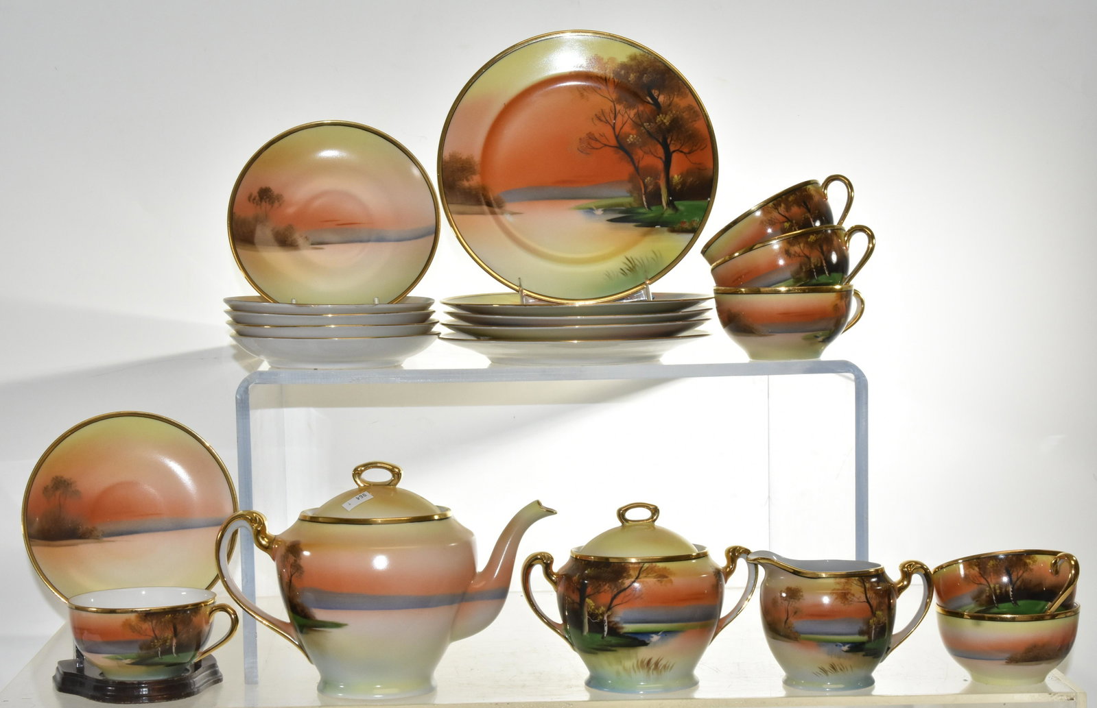 Noritake "Tree in the Meadow" Tea Set: Including an approx. 6"h teapot. Lot also includes a creamer and sugar and six cups and saucers with under plates.