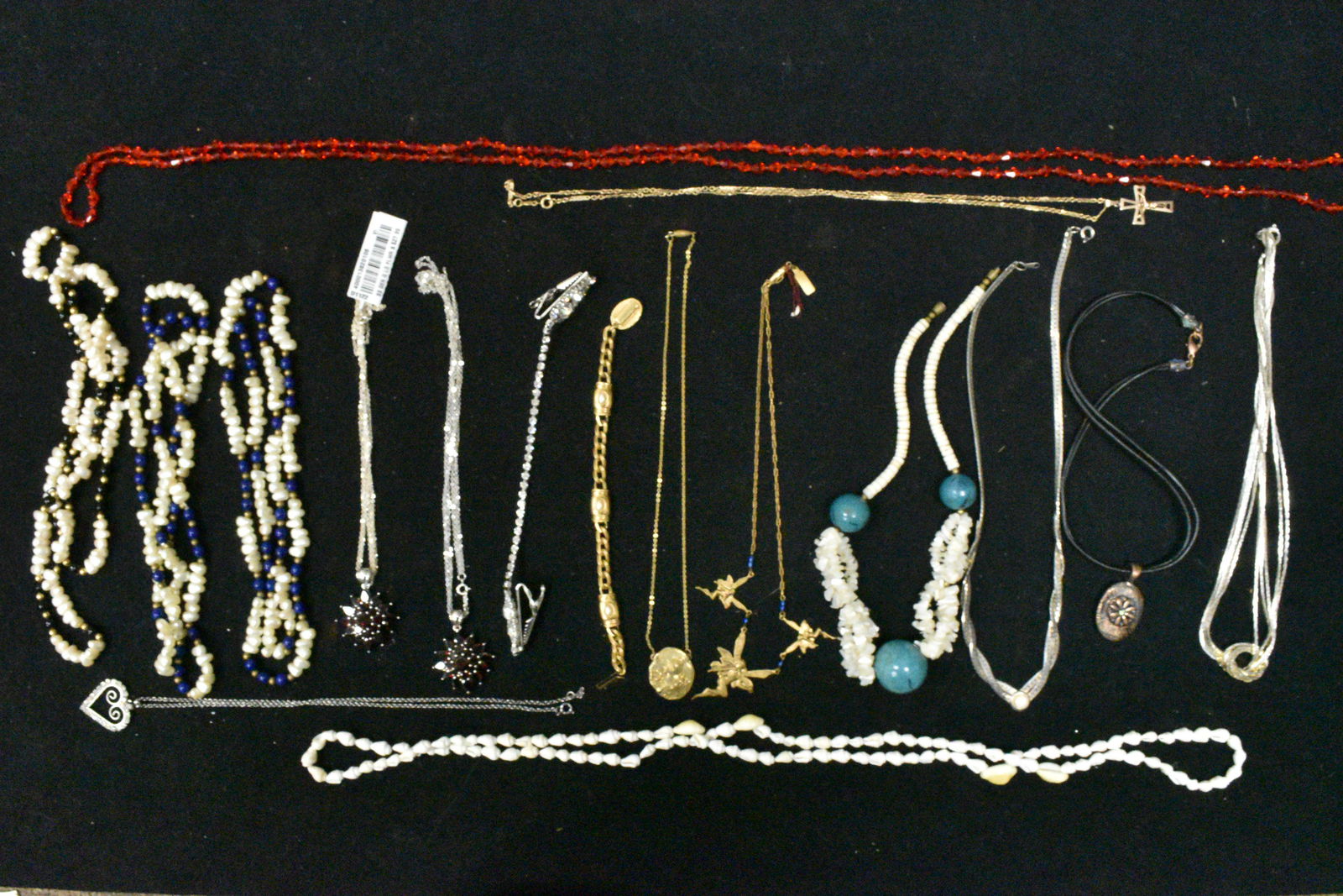 Beautiful Jools, Pearl and Other Beaded Necklaces: Including a fairy necklace marked "Beautiful Jools", two fresh water pearl necklaces with blue beads, two necklaces with red pendants, a crucifix with a gold filled chain and other items.