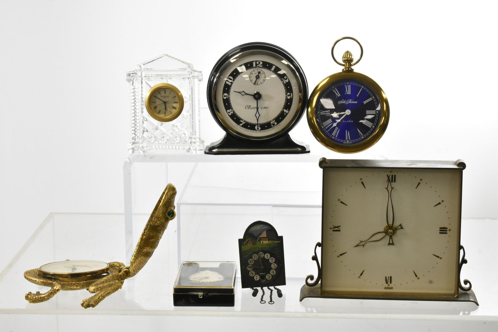 Mixed Grouping of Clocks: Including an Art Deco German alarm clock measuring approx. 6"h, a Westclox Mark 400 calendar pocket watch NIP, a Florn West German alarm clock inside a brass frog (frog is marked Gruber) and more. Fro