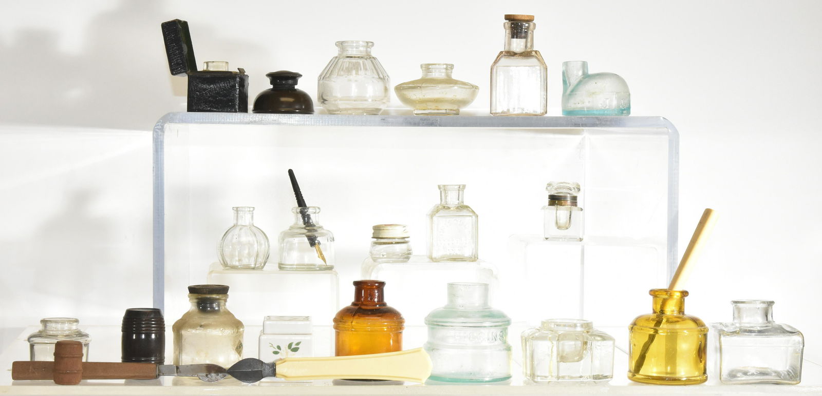 Ink Bottles and Ink Wells: Four ink wells - one is in the form of a barrel and a crystal ink well with brass mounts. Lot also includes fourteen ink bottles.