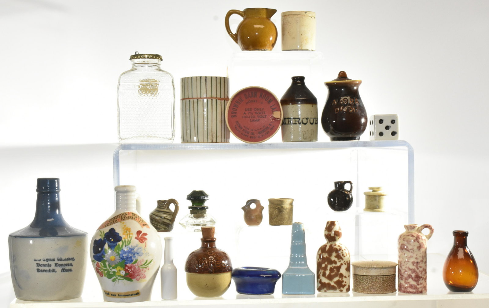 Vintage Stone Ware and more: Lot consists of Dennis Donovan whiskey jug measuring approx. 6 1/2"h, and various small stone ware items including a Mercury bottle, a meat juice bottle, and ink well and more.