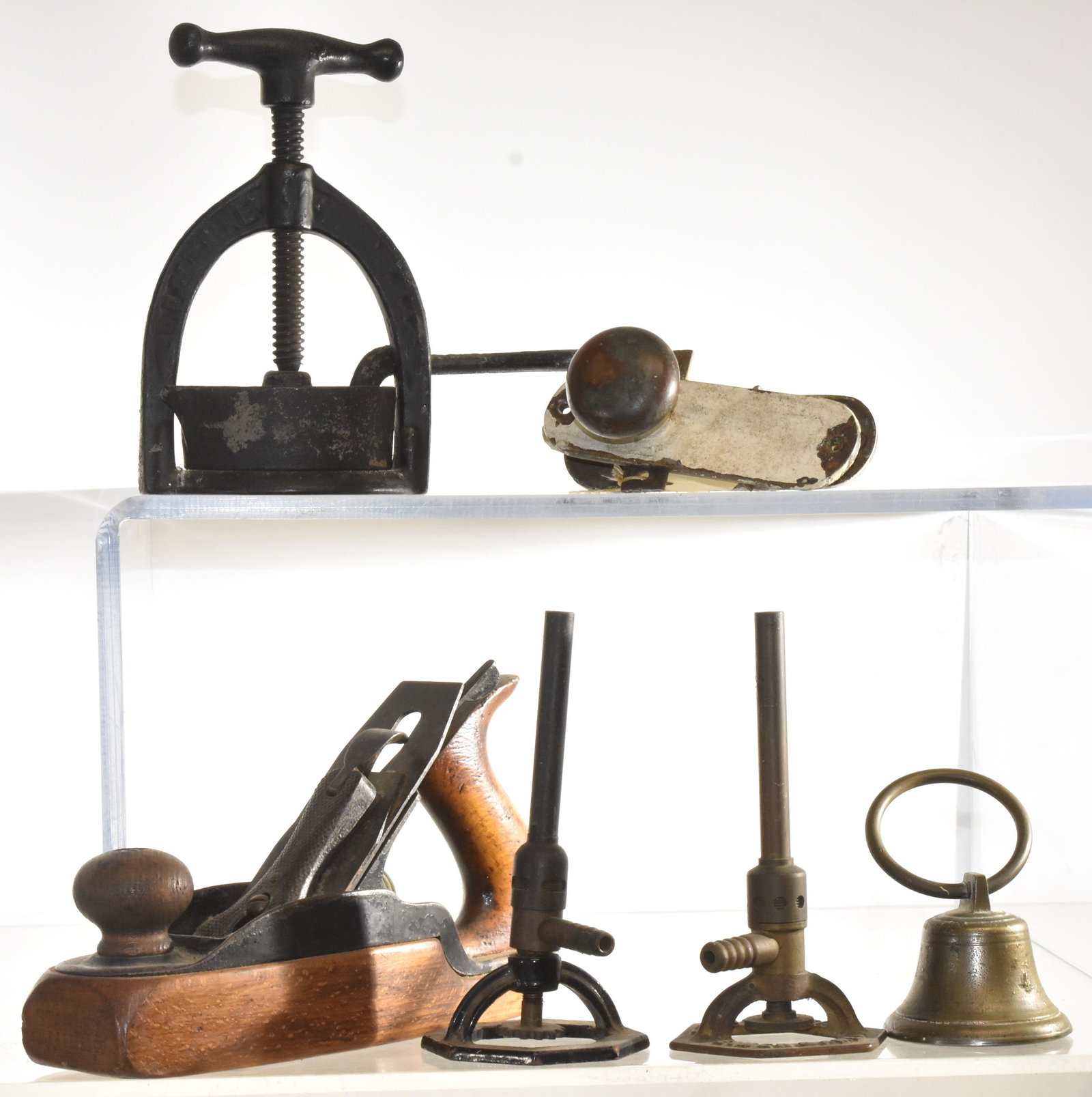 Mixed Vintage Tools: A Stanley plane, a meat juice press, two vintage sprinklers, a bell and a door knob.