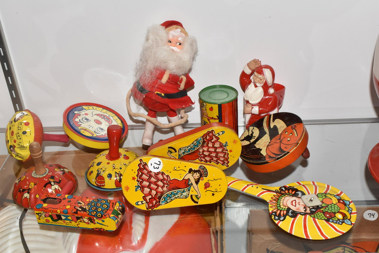 Vintage Noise Makers and more: Includes ten noise makers - one is Halloween marked "Made in USA" and several of the others are marked "US Metal Toy". Lot also includes two vintage Santas - one is a candy containers One noise maker 