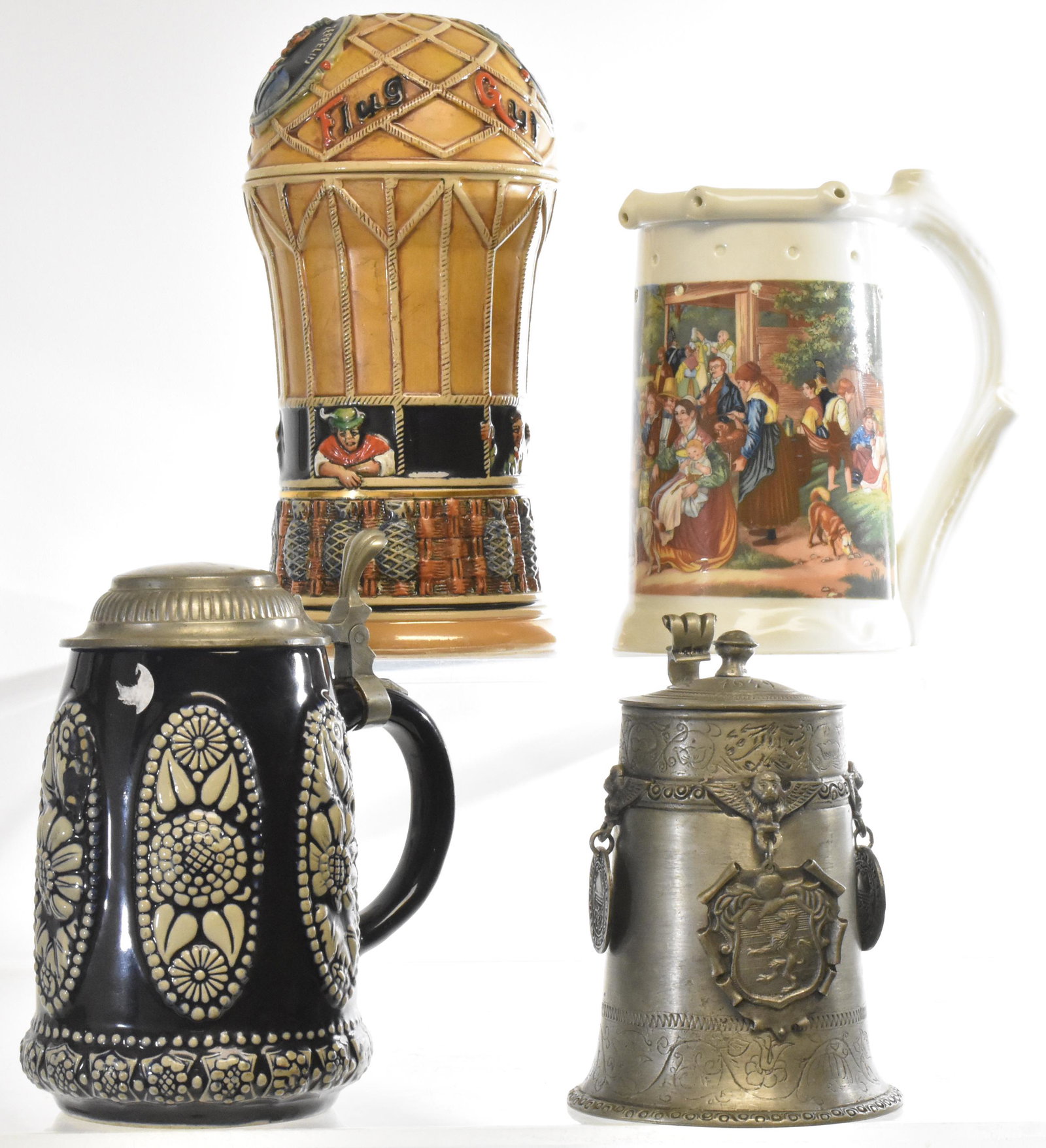 German Graf Zeppelin Stein and others: Zeppelin stein measures approx. 10"h and was made by "Corzelius". Also a cobalt stein which is numbered, a trick stein marked "Geo. Gesch" with a nude litho pane and a pewter stein with a German tag. 