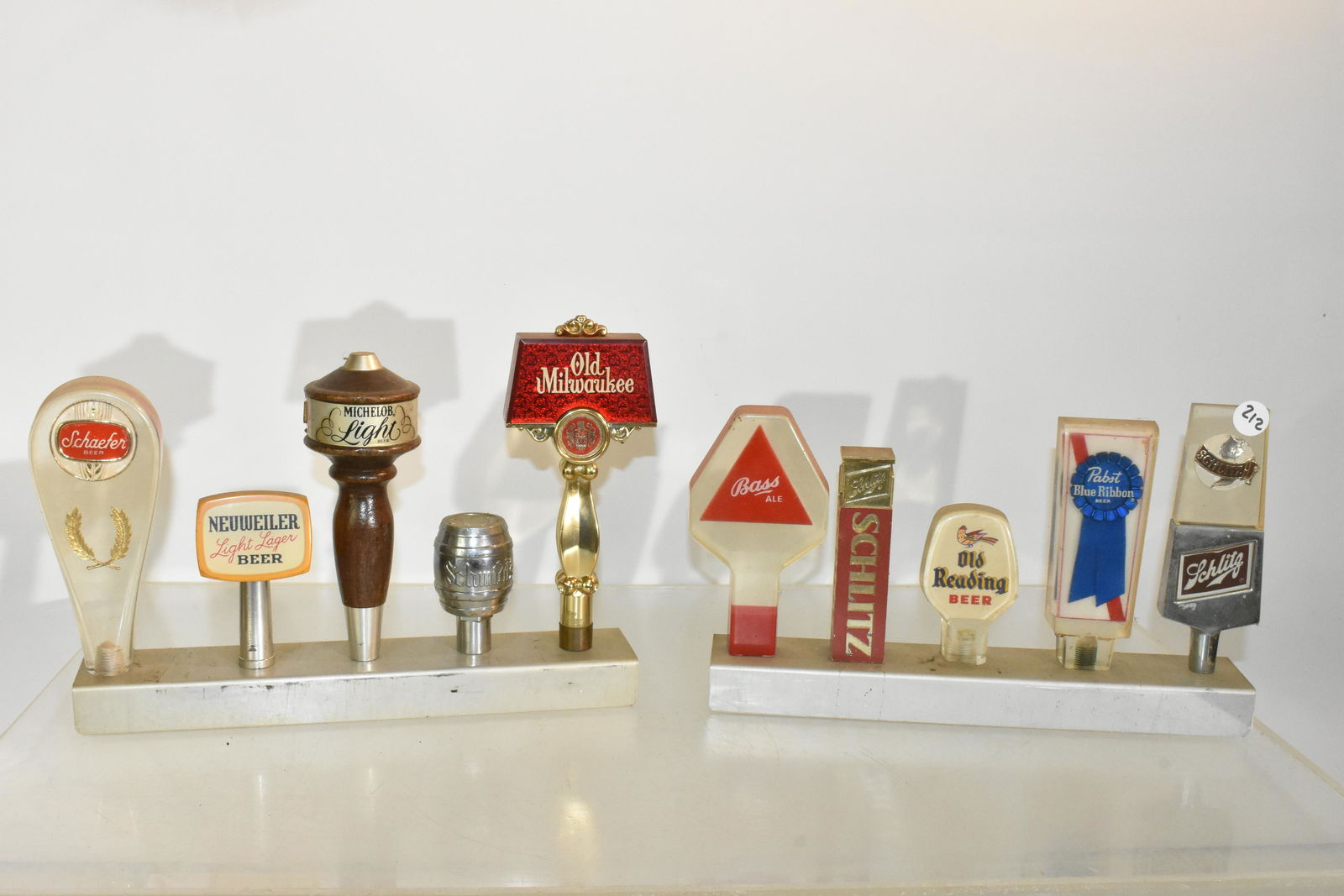 Ten Vintage Beer Taps: Ten beer taps on display stands, attached with nuts.