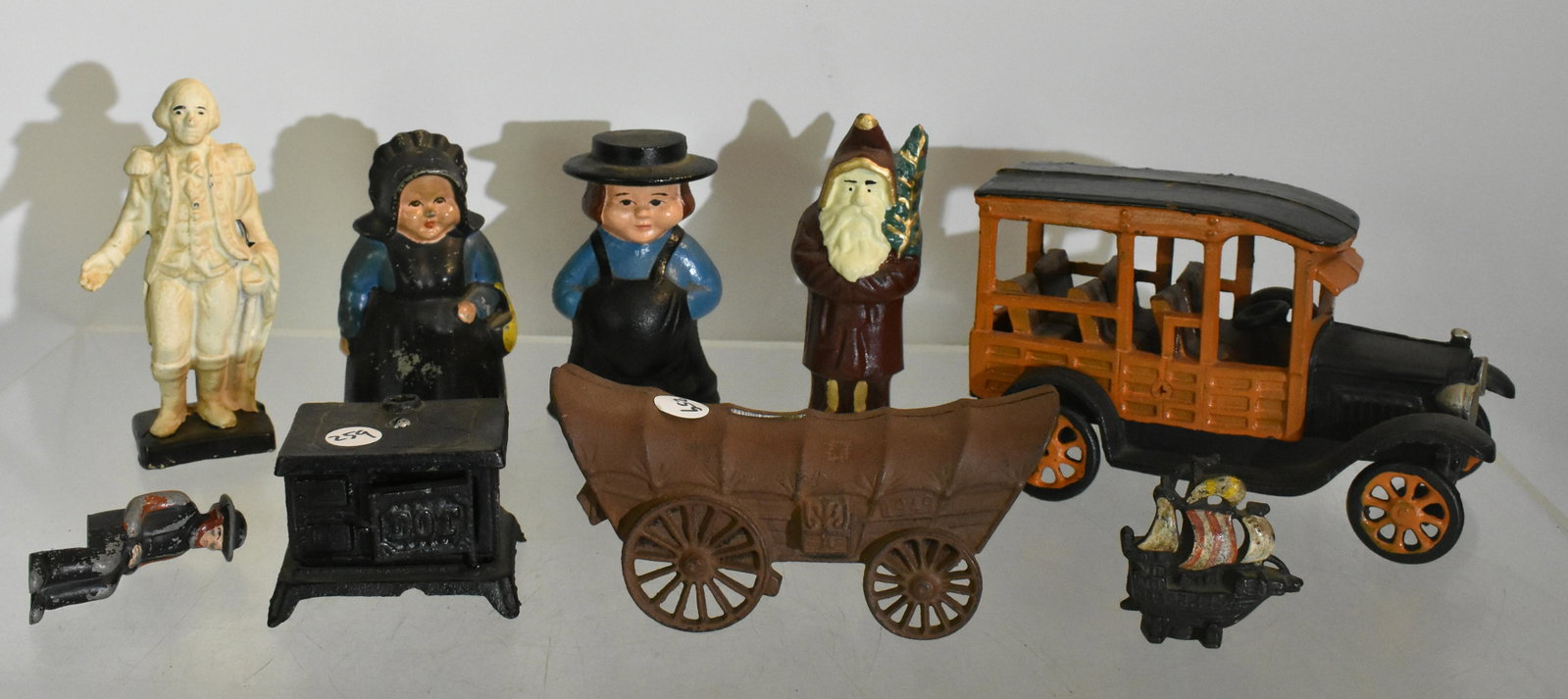 Contemporary Cast Iron Grouping: A large car, Amish people and more.