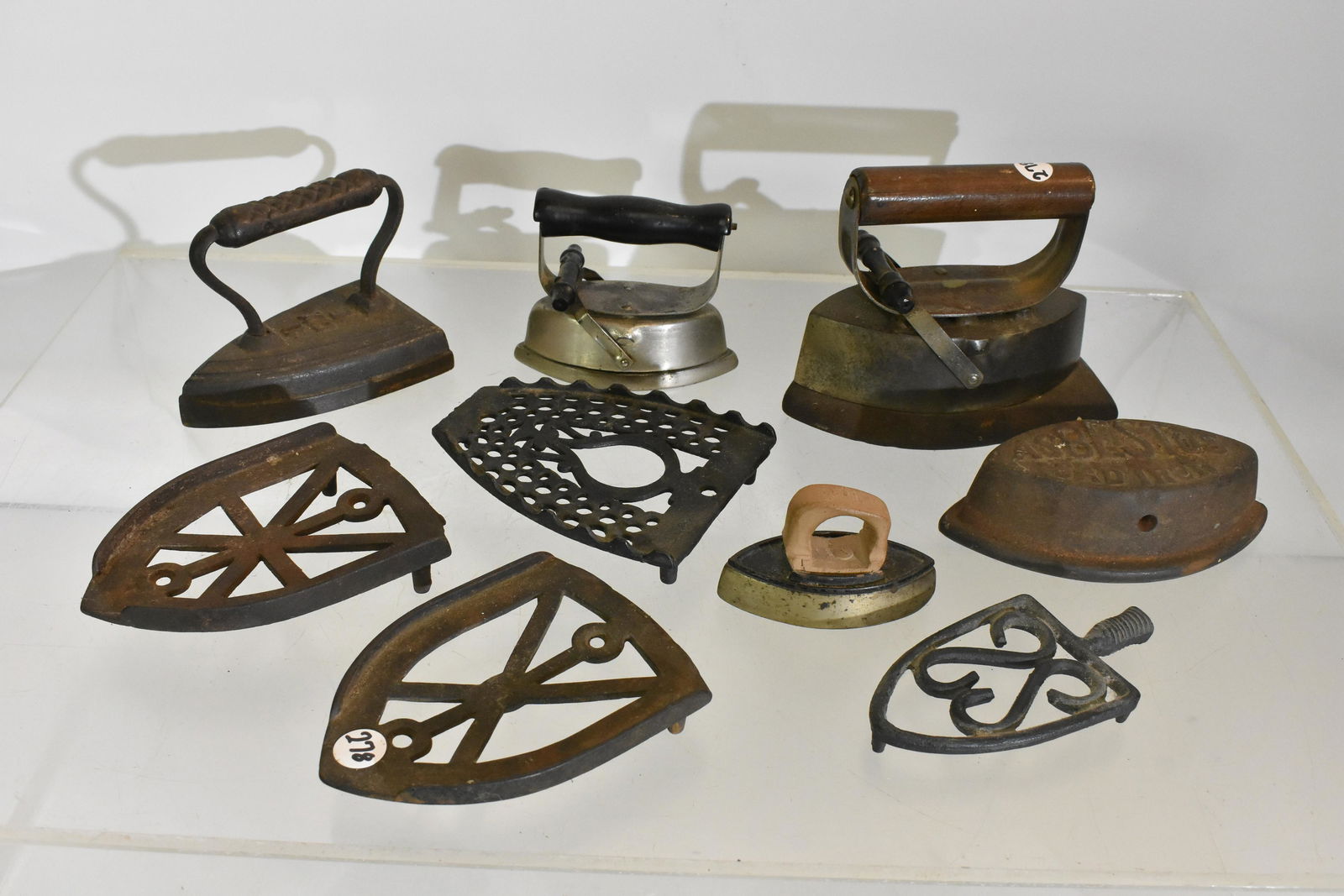 Sad Irons and Trivets: Five sad irons and five trivets.