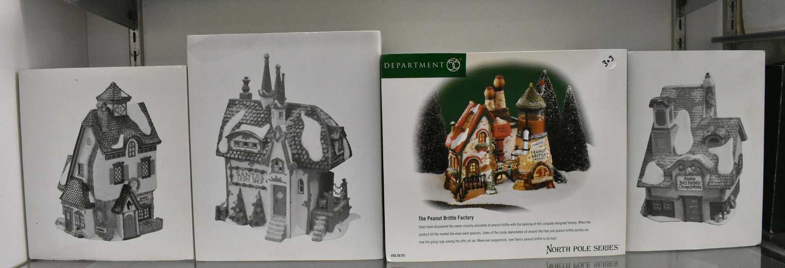 Dept 56 North Pole Series NIB (4): Neenee's Dolls and Toys, Santa's Light Shop, Peanut Brittle Factory and Santa's Bell Repair.