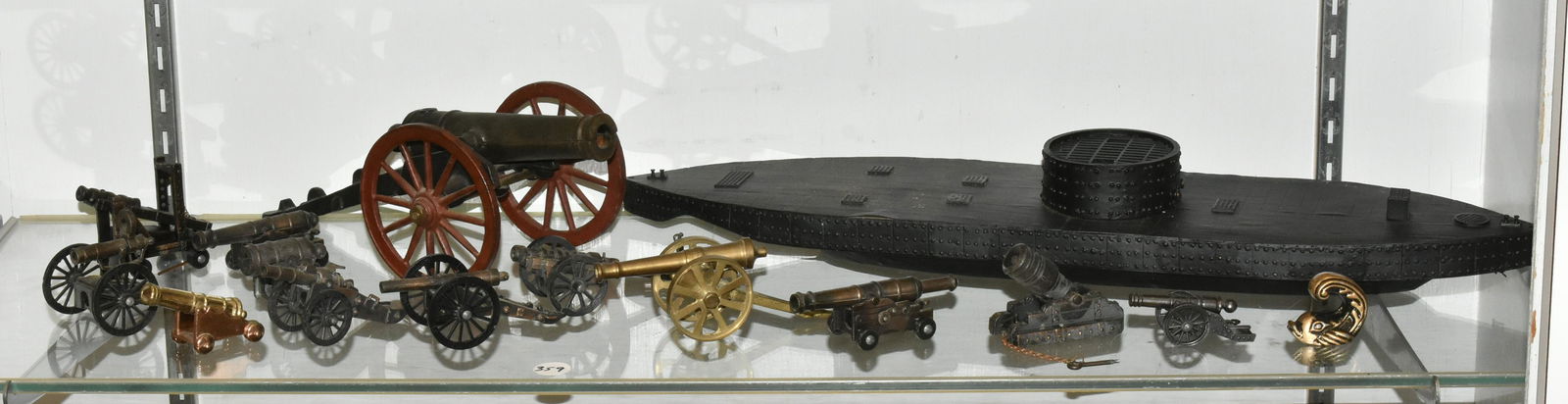 Miniature Cannons and Models: wooden model of Ironside submarine approx 20" long, largest cannon measures 10" long and 4" high of the 13, several are pencil sharpeners, some have triggers.