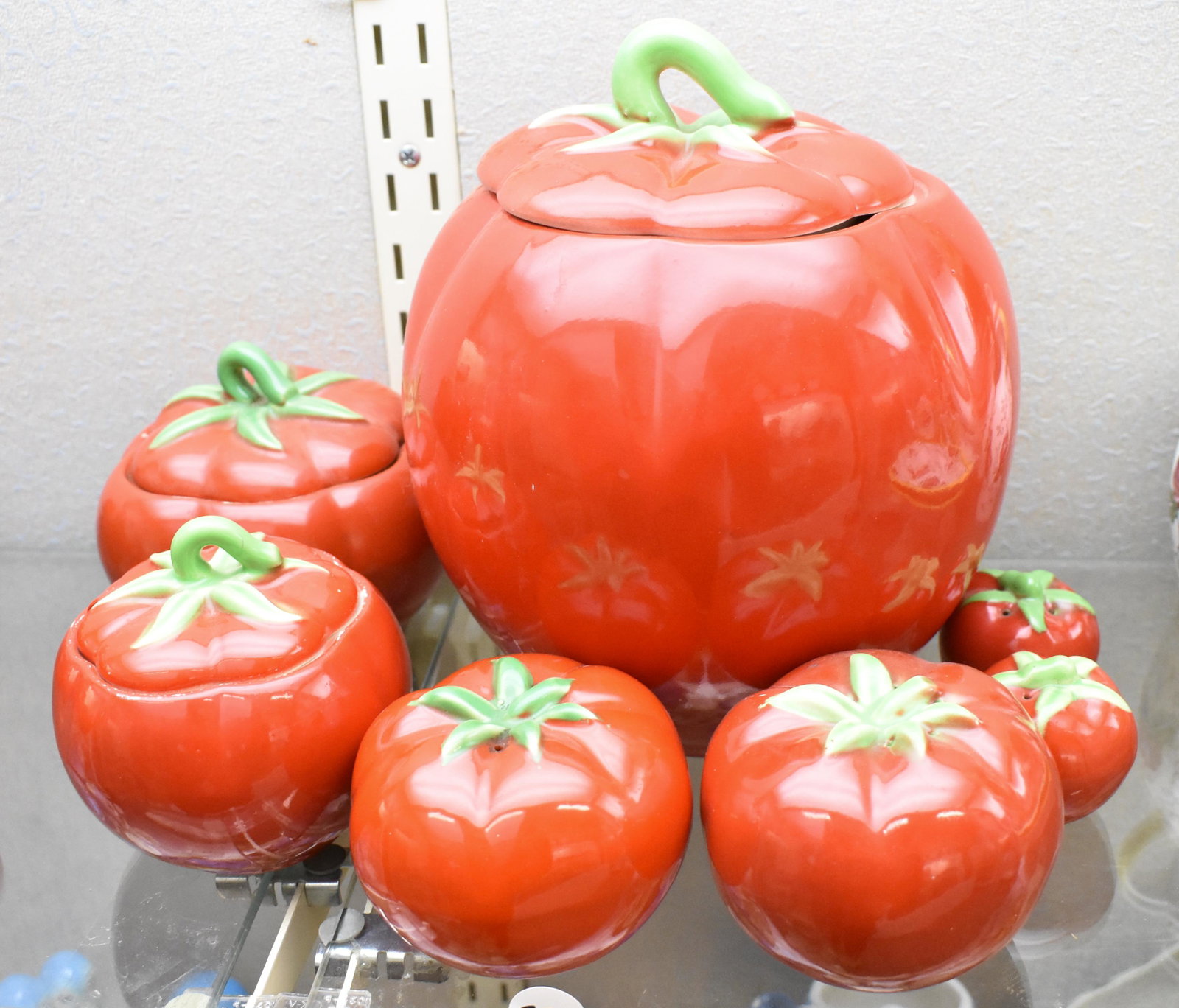 Pantry Parade Ceramic Tomato Dishware: Cookie jar with lid, sugar bowl with lid with hole for spoon, larger bowl with lid, and two large shakers and two small shakers (small are missing corks).