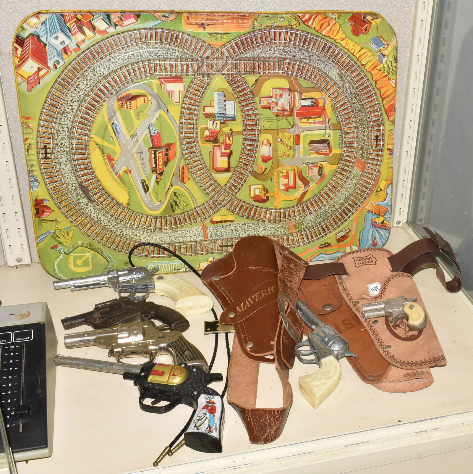Western & Military Style Collectibles: Including a US Marine Corp Semper Fi cap gun holster, Maverick cap gun holster, and another cap gun holster. Plus a Trooper Pistol, Lone Ranger plastic gun (works), and 2 other pistols (1 revolver wor