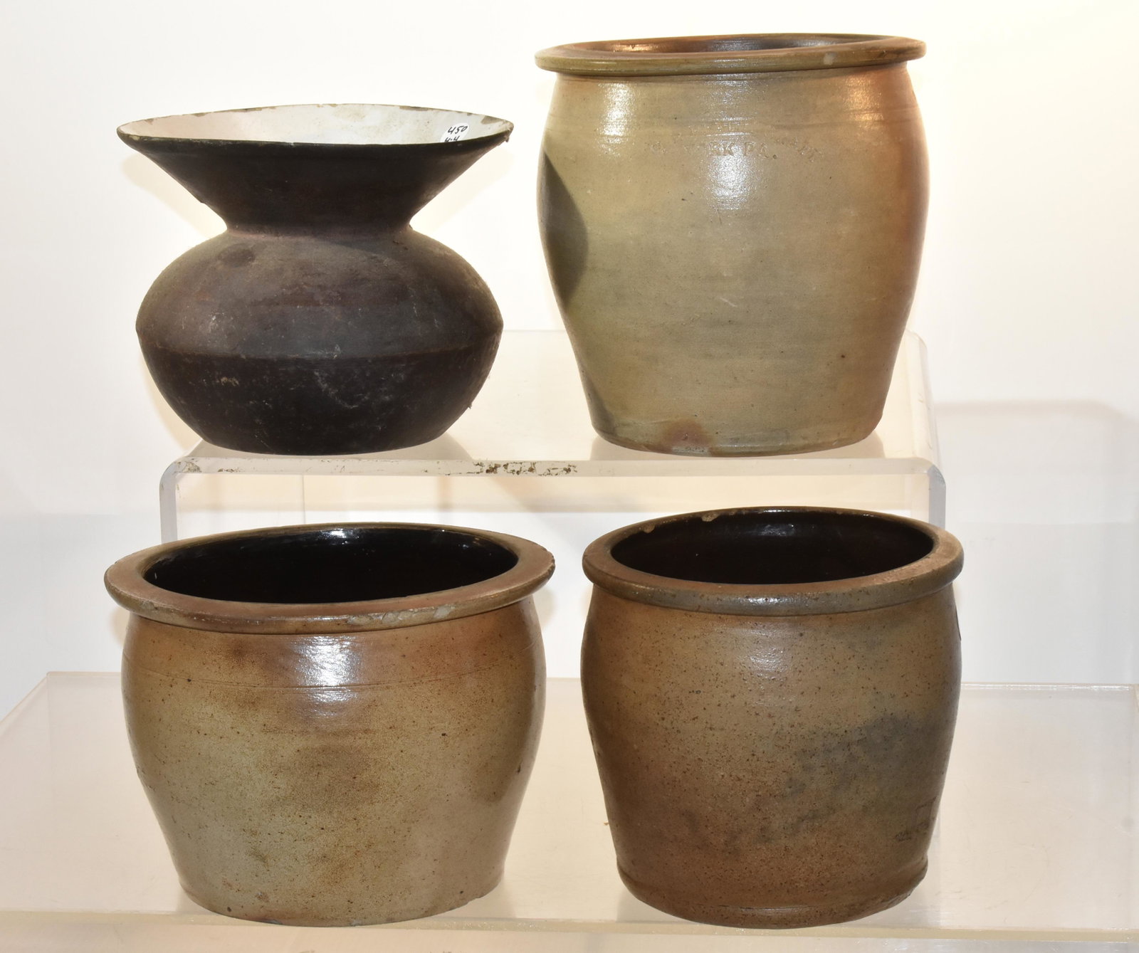 19th Century Crocks and a Spittoon: Three crocks - largest measures approx. 8 1/2" h and is marked H B. Pfaltzgraff " All crocks have small chips. Lot also includes a cast iron spittoon with an enameled interior.