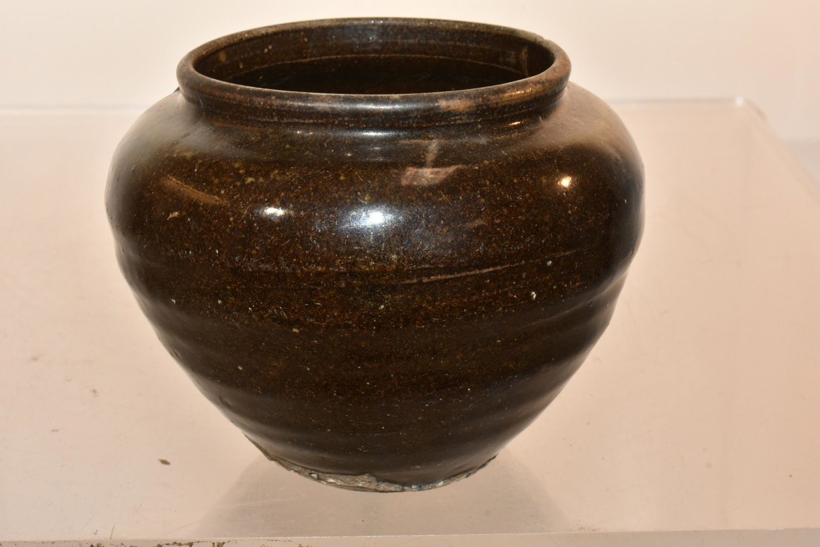 Early Asian Brown Glazed Pot: Believed to be approx. 300-500 years old from Khmer Cambodia, this brown glazed pot has a large repair on the side.