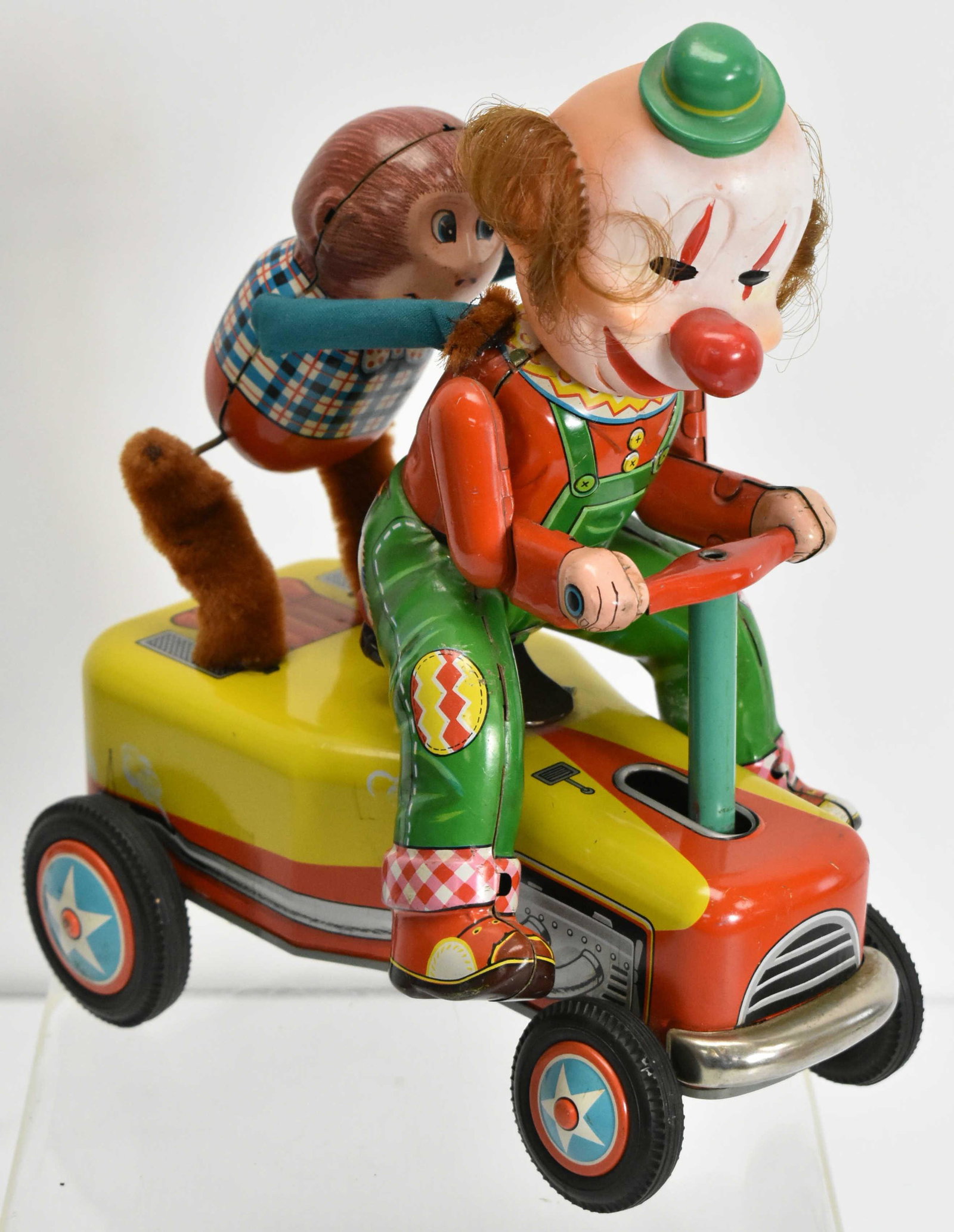 "Modern Toys" Tin Litho Clown and Monkey on Car: Battery operated tin litho toy measuring 10" high x 8" long, circa 1950's, made in Japan, #3478 on license, no box