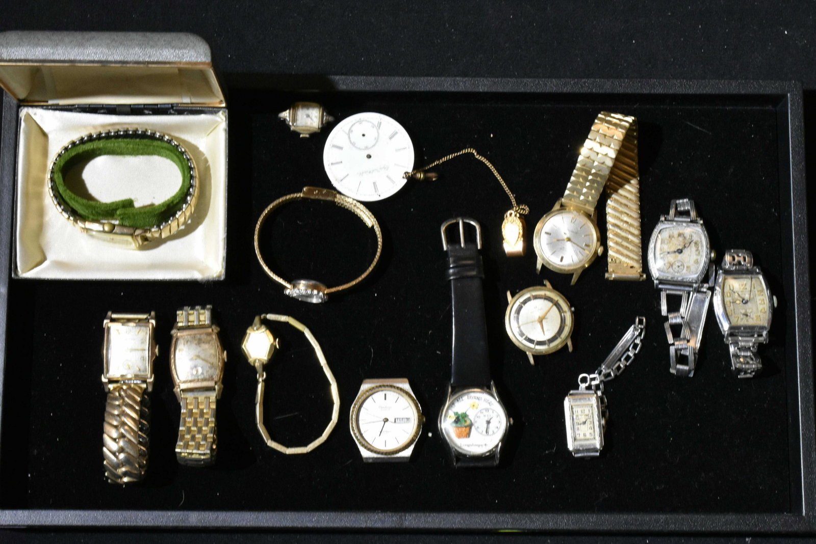 Grouping of Vintage Wrist Watches: A Valencia marked Swiss, an Elgin, a Carvel, a Bulova and an Armitron. 12 watches and various movements.