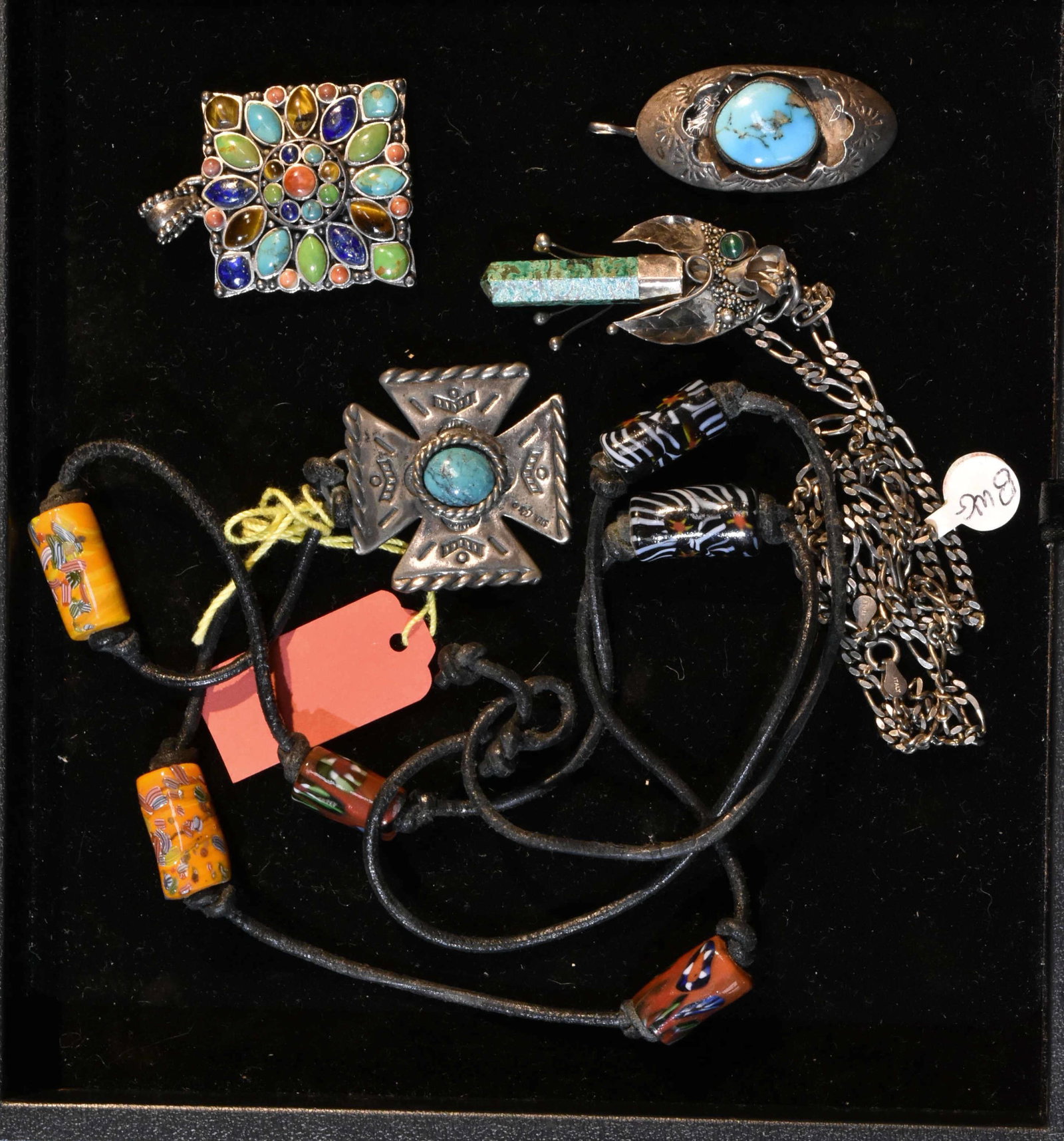Vintage Sterling and Stone Jewelry: A Navajo sterling surfer's cross on a beaded rope, two sterling and turquoise pendants - one with chain and a sterling pendant with multi colored stones.