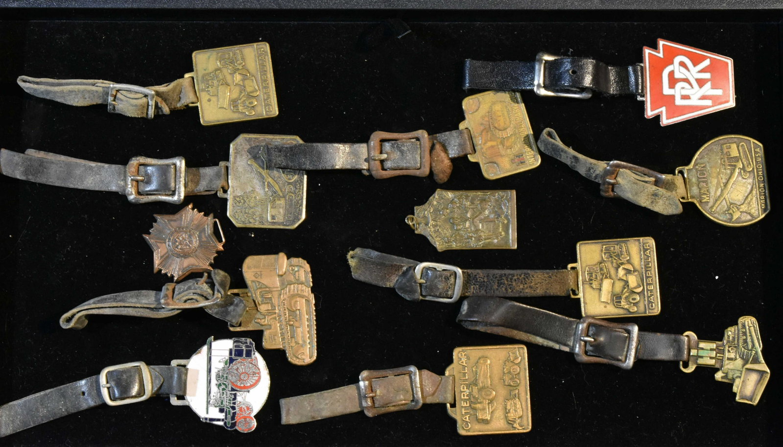 Collection of Fobs: Including a PRR fob, Caterpillar fobs, an International Forester fob and others. 12 total pieces.
