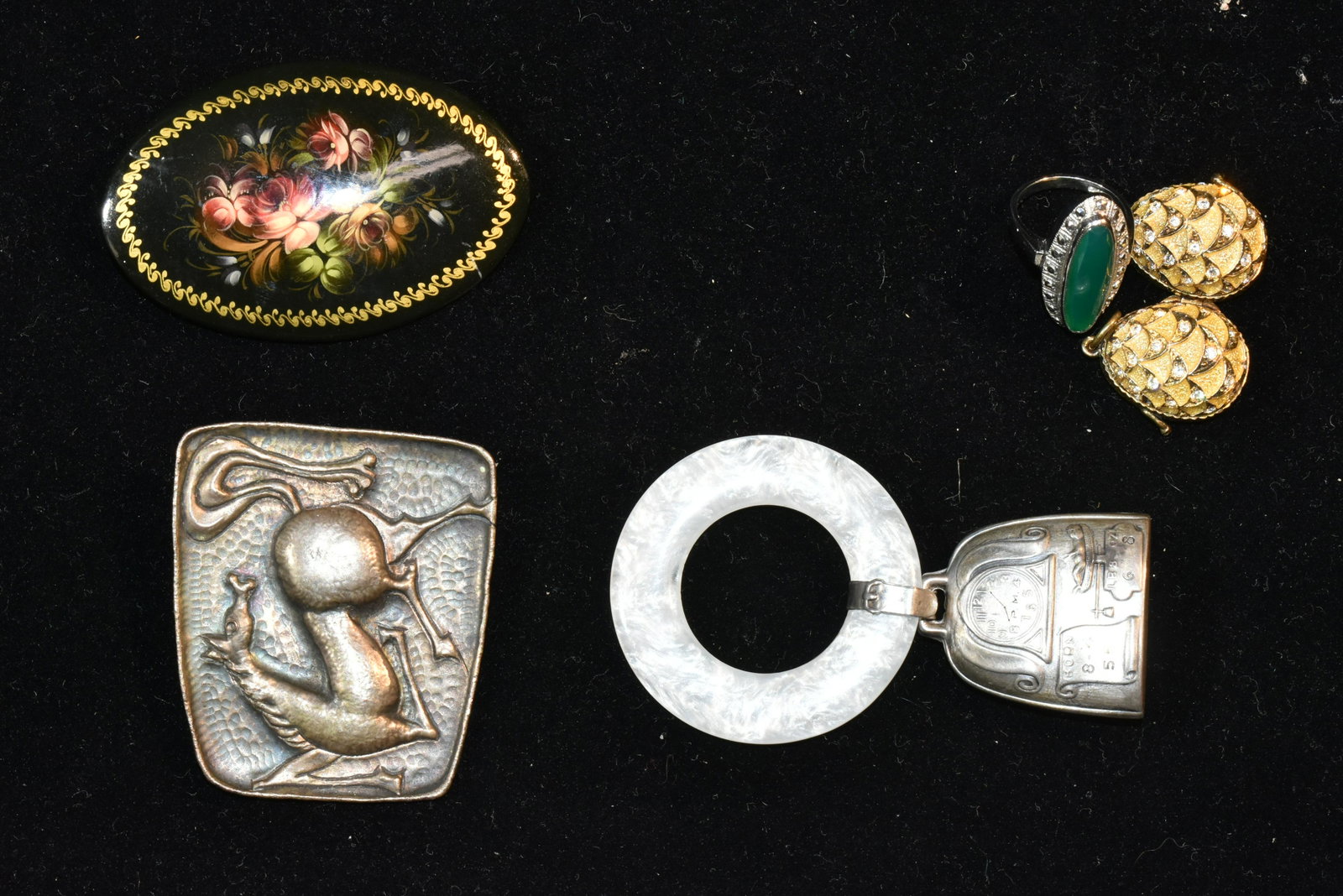 Eclectic Sterling Jewelry Collection: Including an artisan sterling Picasso style mid century horse brooch, a 19th century sterling baby rattle, a sterling jade and marcasite ring and a sterling egg pendant.