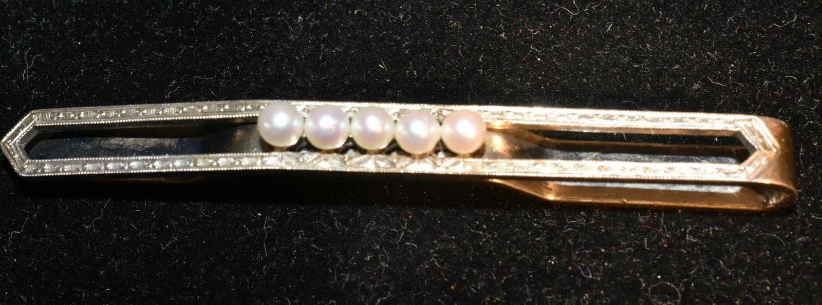 Mikimoto Tie Bar: Silver tie bar with an etched body and five pearls and is signed "M".