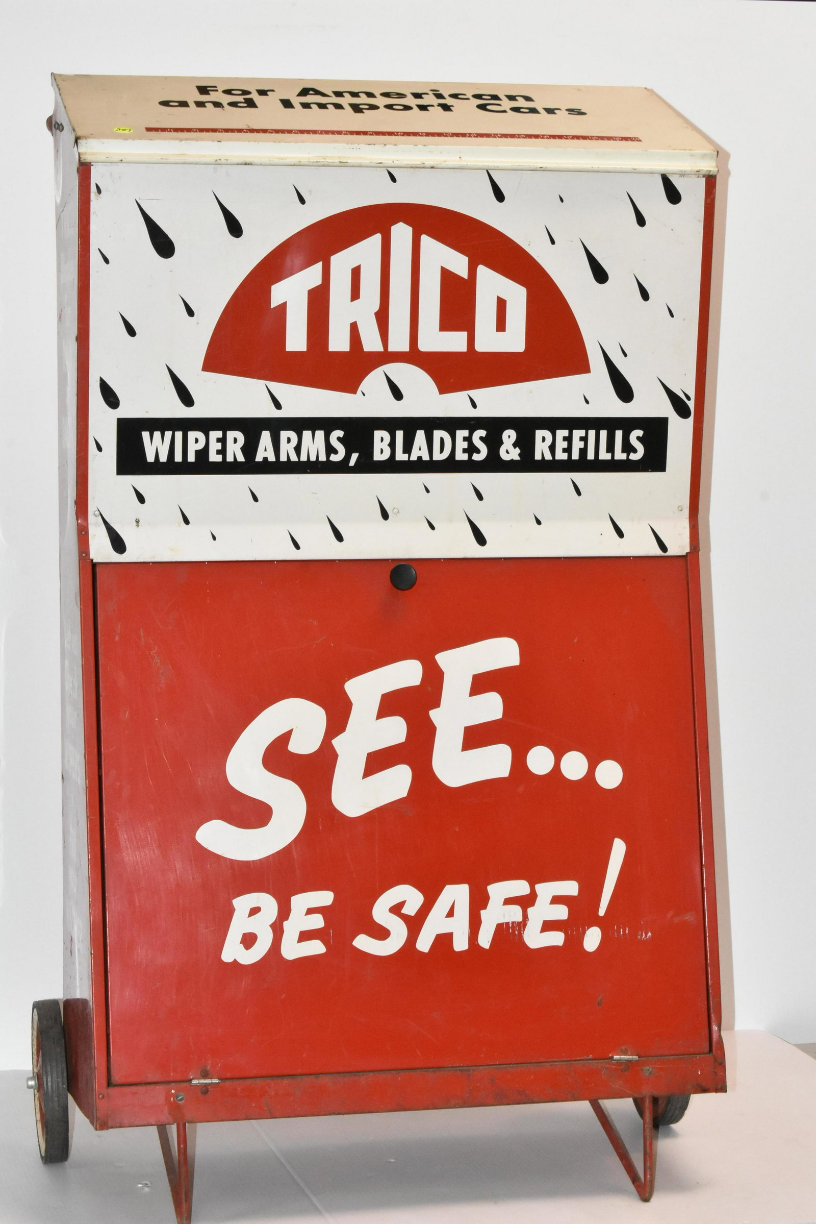 Trico Windshield Wiper Mobile Display: Measures approx. 45 1/2"h x 26"w x 15"d from back of wheels to front. It has good graphics, a lift top lid, interior blade holder and a drop front door with rack and original paperwork. Item has origi