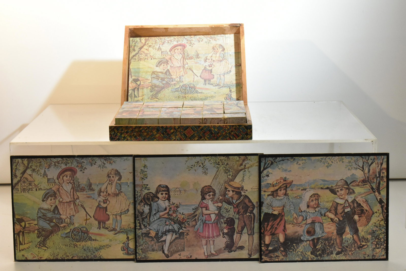 Victorian Four Sided Puzzle Block Set: Measures approx. 2 1/2"h x 10 1/2"w x 9"d. Item is a wooden box with paper covering and contains a full set of four sided puzzle blocks along with three two sided puzzle maps.