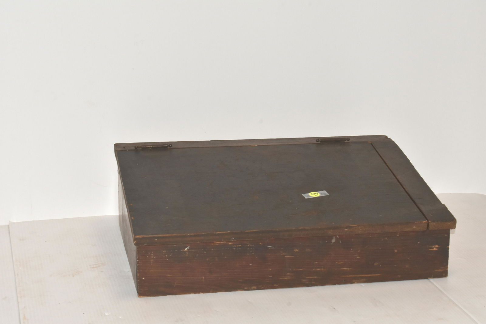 Table Top School Desk: Measures approx. 7"h x 22"w x 16"d. It is mixed wood construction with an old plywood top and has original hinges.