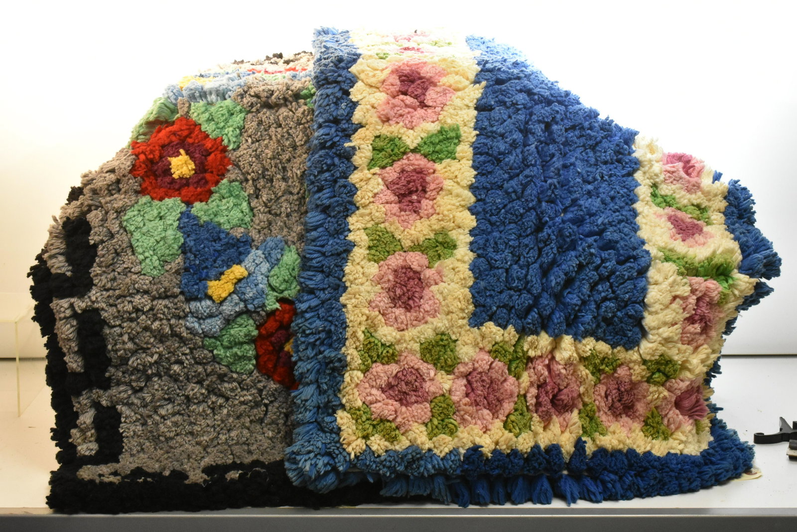 Two Hand Made Throw Rugs: Each measures approx. 38"h x 22"w. Both are completely hand tied and delicately used.