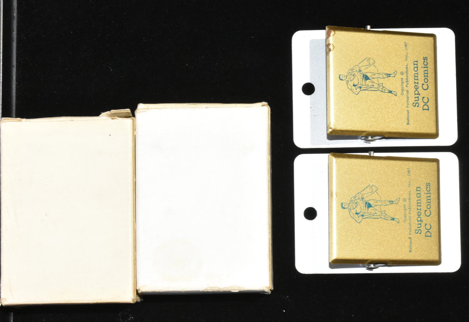Pair of 1967 Superman Note Clips NIB: Each measures approx. 3 1/4"h. They depict Superman and read " Copyright National Periodical Publications, Inc. 1977 Superman DC Comics". Both have original box and one has minor oxidation at top.