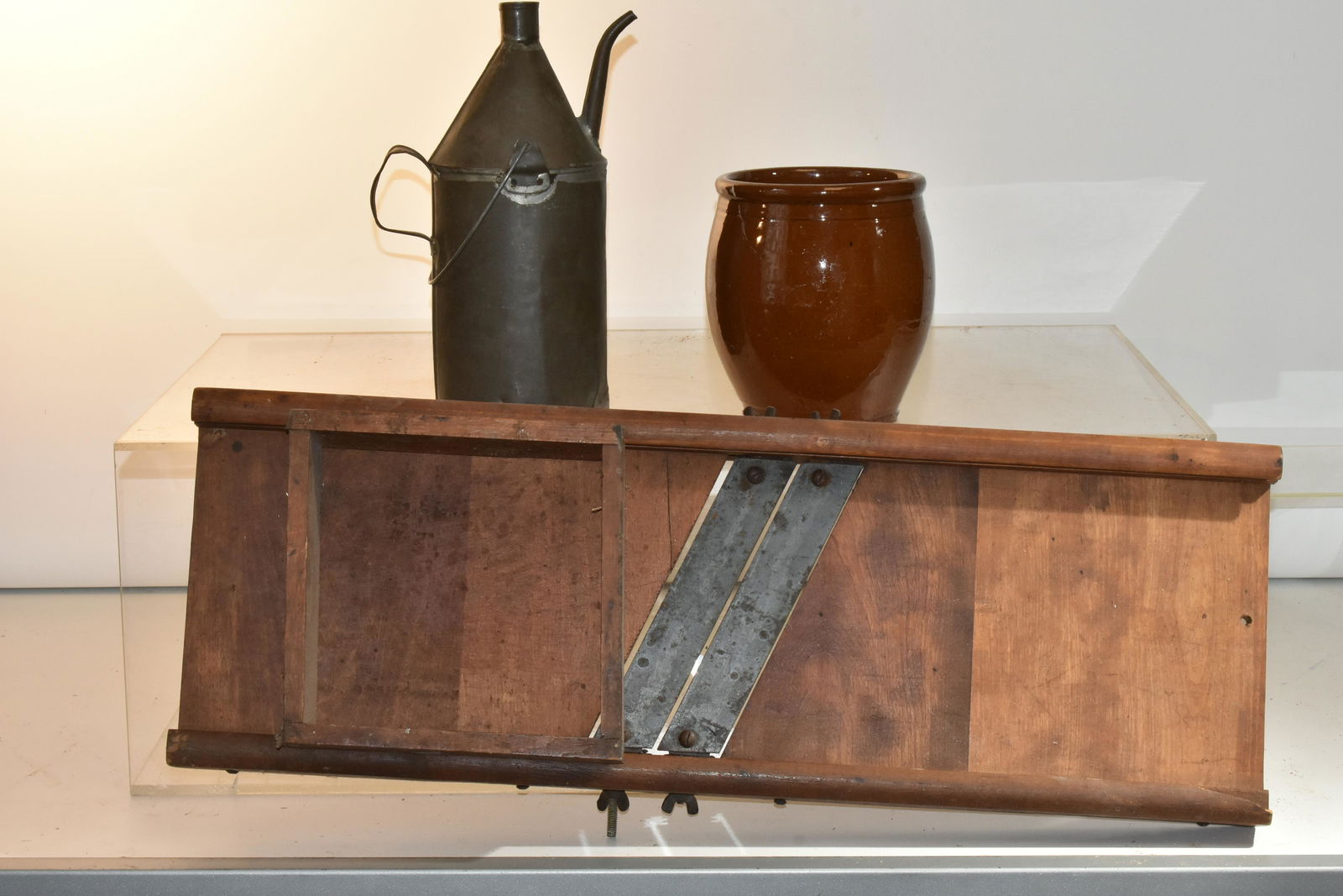 Mixed Country Grouping: Lot includes a slaw board with box, a wooden clamp, a contemporary theorem, a metal fluid can with dents, and a redware crock with cracks.