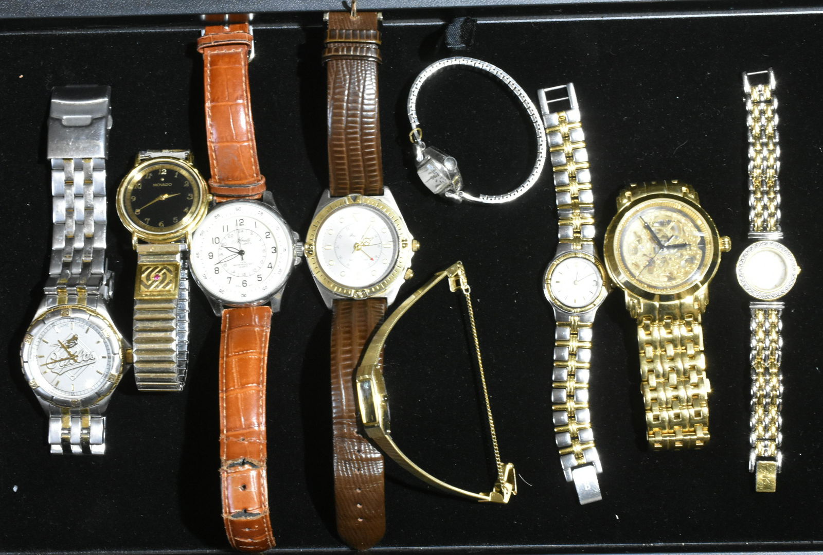 Ladies and Men's Watches: Ladies' watches include Pulsar, Anne Klein, Dominique, and Bulova. Men's watches include Stuhrling skeletal watch, Baltimore Orioles, Movado, and others.
