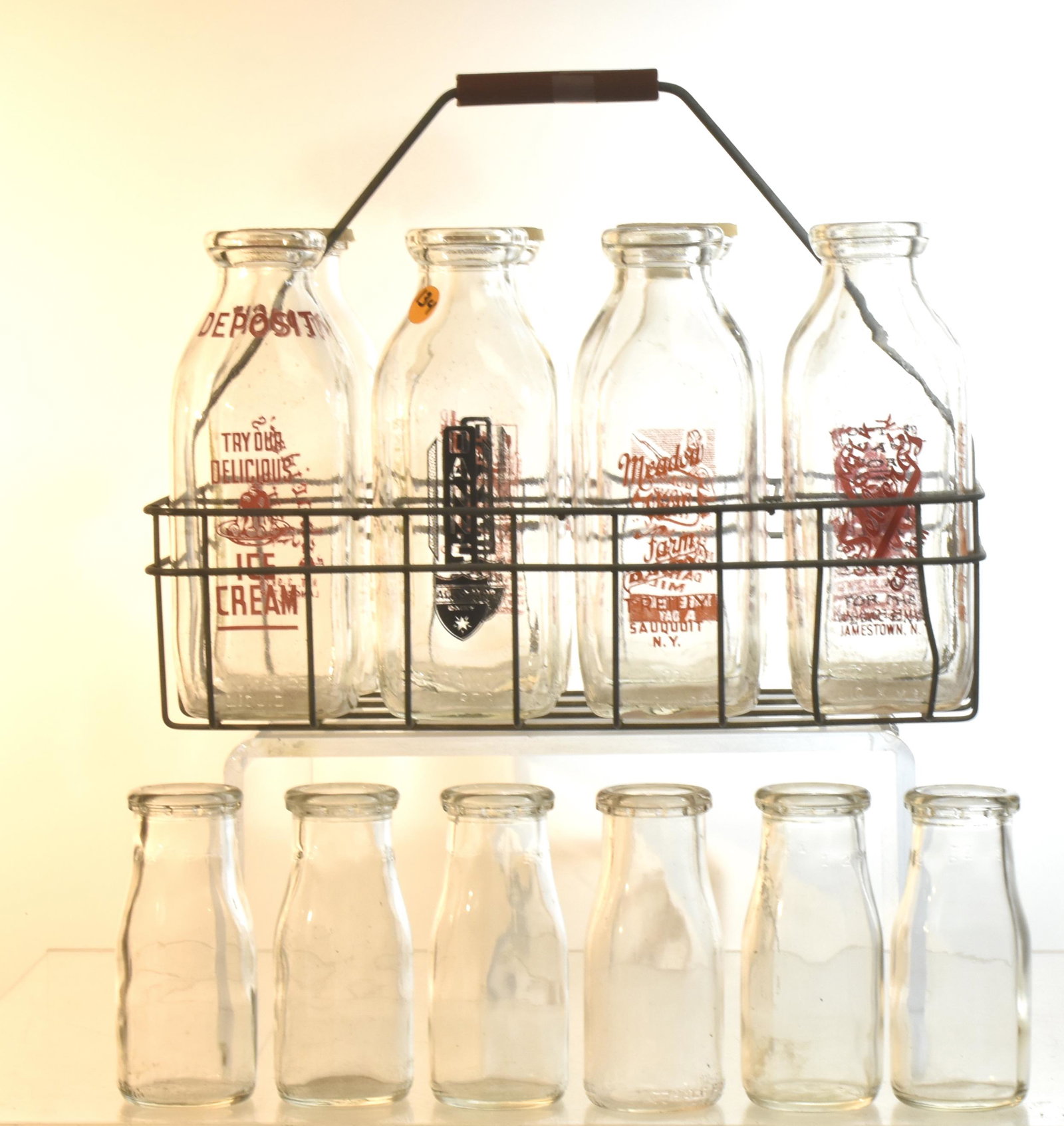 Vintage Milk Bottles and Carrier: Bottles include Danns, Meadowview, Seibergs, and others. Total (14) bottles and vintage carrier.