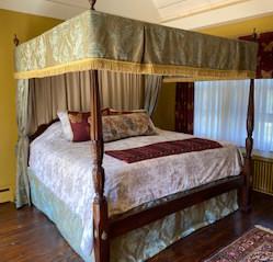 Chippendale-style Cherry Four Poster Bed (King): From top down it has carved finials, then canopy with silk valance and rods and back drapes and 4 corner draperies (only 2 show in photo) which can also be used as curtains. Carved tobacco leaf design