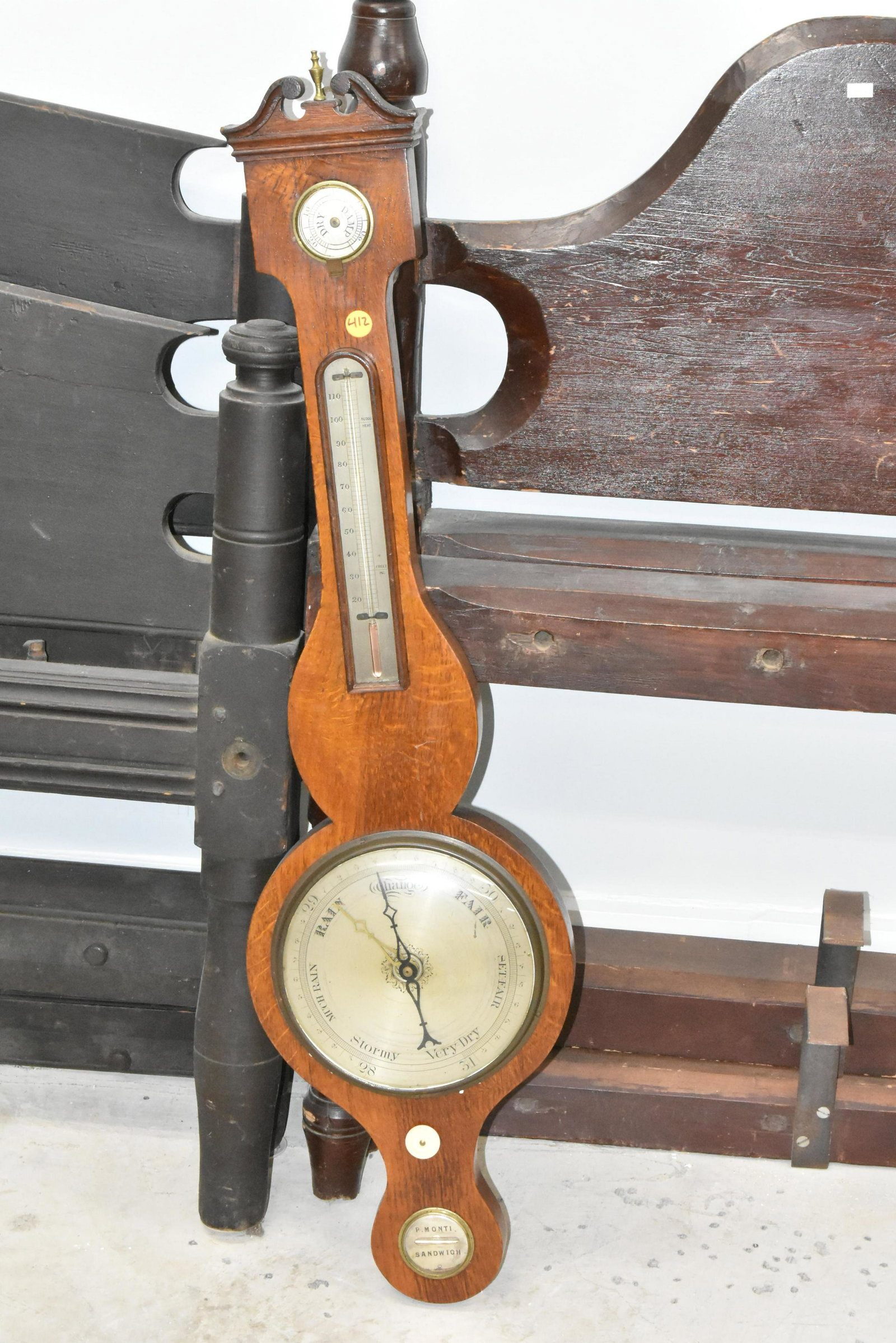 19th C P. Monti Sandwich Barometer: Item measures approximately 39"H. It has a solid oak case, and it retains original brass finial. The dry/damp hand is missing, the mercury is lost. Item is otherwise complete.