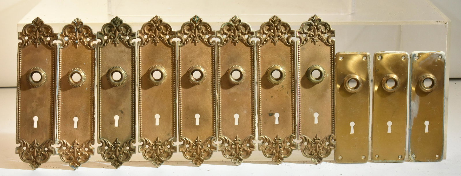 Victorian Brass Door Back Plates: Lot includes (8) matching back plates. They are solid brass and they measure 9.5"H each. Lot also includes (3) contemporary back plates.