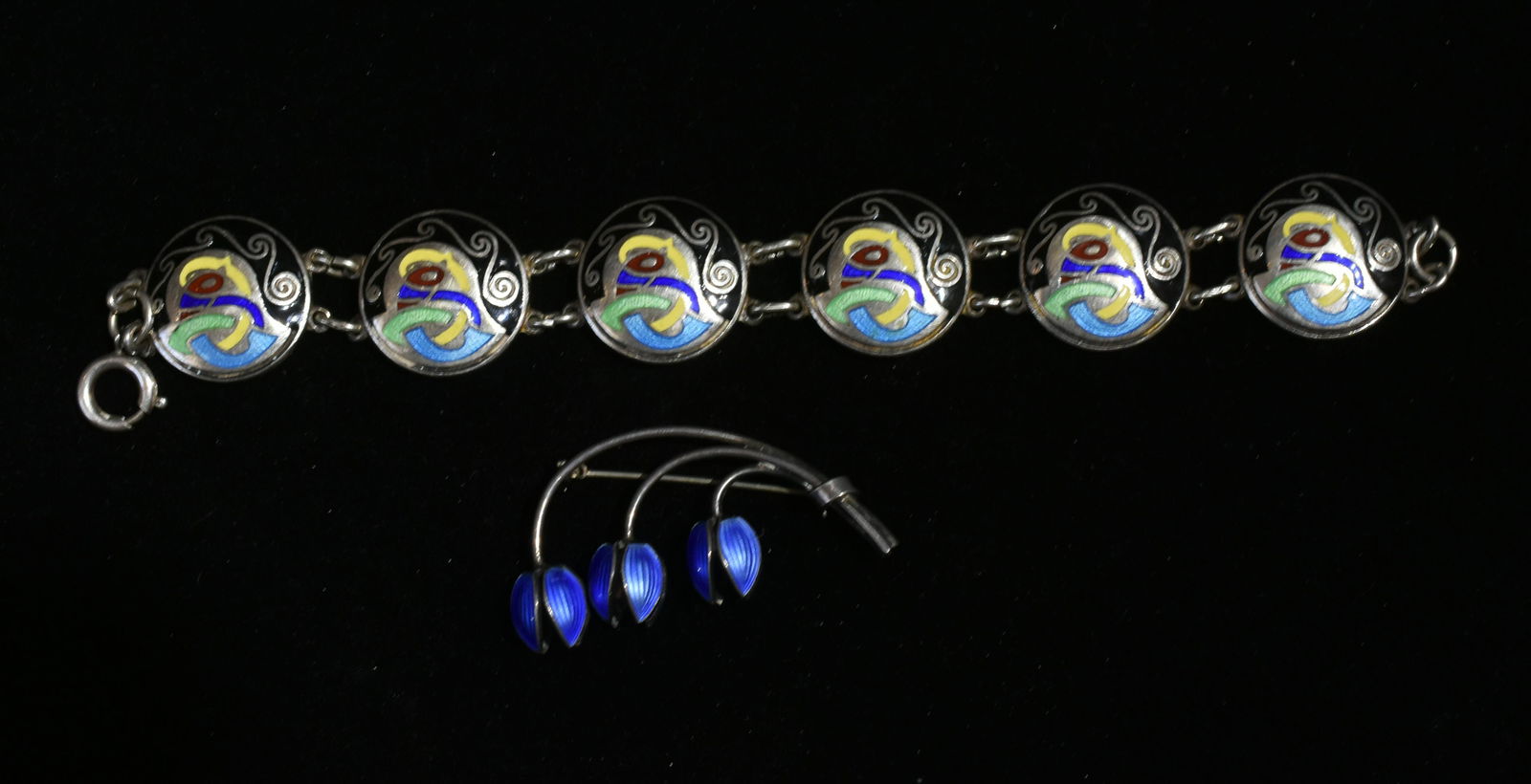 Mid-Century Danish Sterling Jewelry: Lot includes a bracelet with colorful enameled discs, signed TW with a clover mark, and a blue enameled triple tulip pin that is possibly David Andersen.