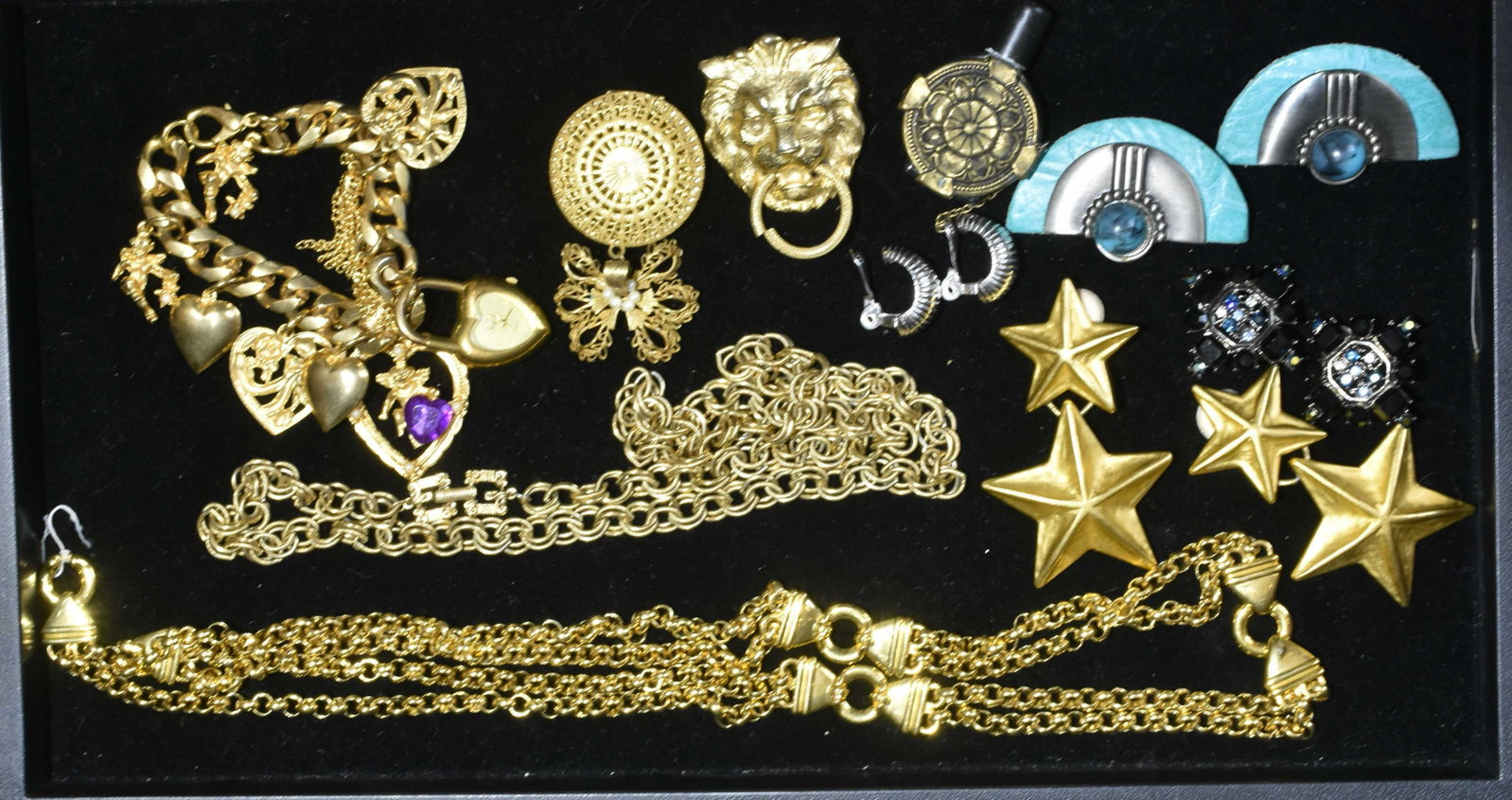 Givenchy and Other Costume Jewelry: Lot includes Givenchy Maltese cross jet black and blue stone clip earrings, a Givenchy necklace, various clip earrings, a heart charm bracelet, and more.