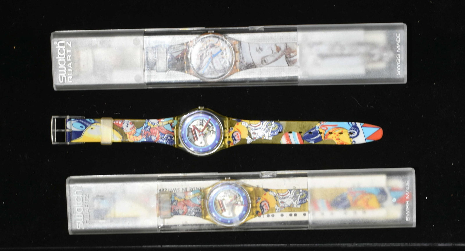 Swatch Watches NIP: Lot includes (2) tin toy style watches, one in pack, and a masquerade in pack. All are 1992, and marked Swiss.