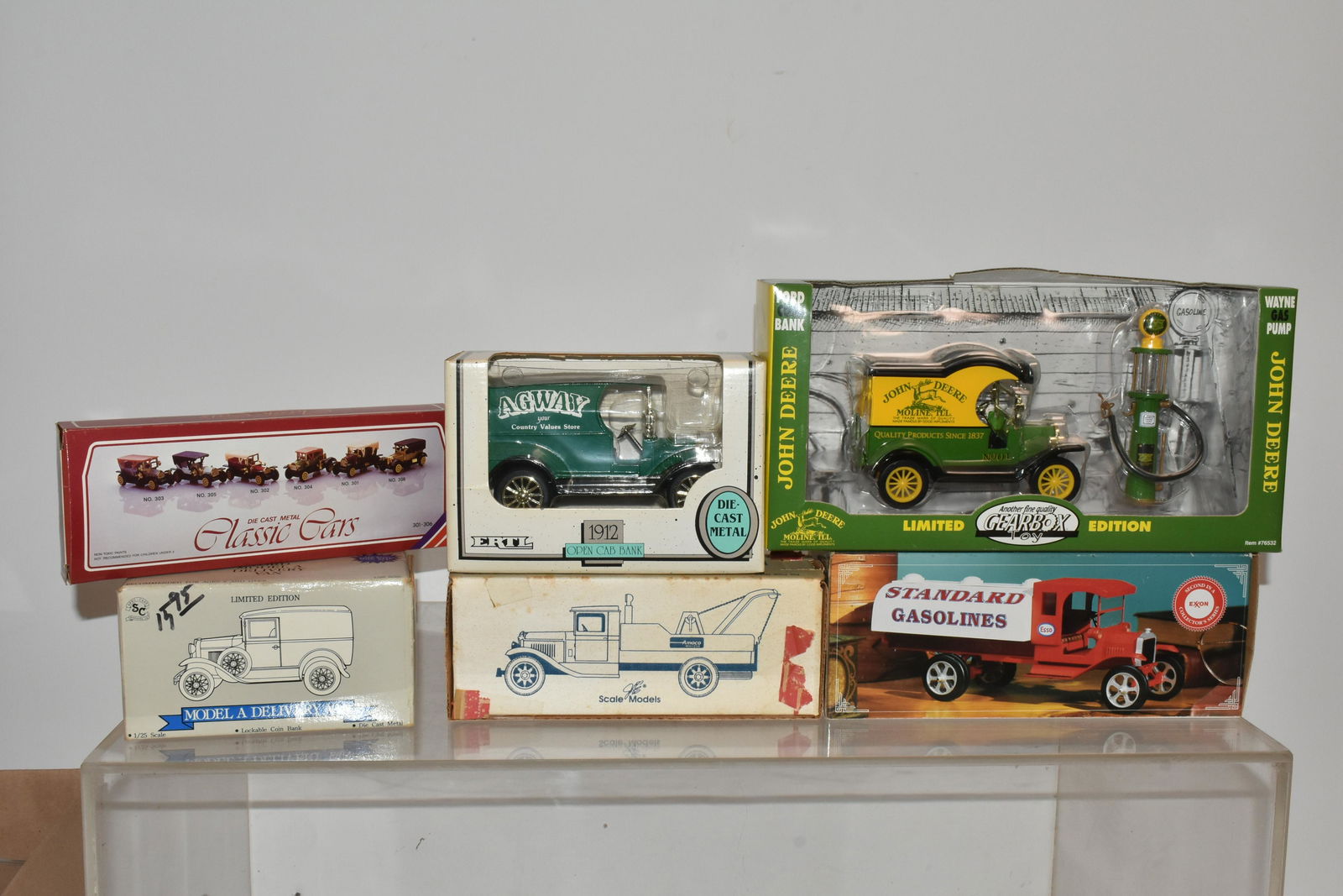 John Deere and Other Die Cast Vehicles: Lot includes a John Deere 1920's truck with gas pump, Ertl, Amoco, and other vehicles. (6 total)