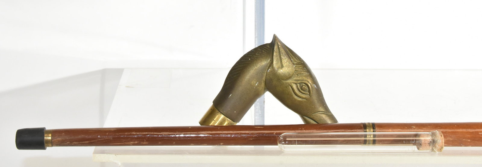 Horse Head Cane with Flask: Cane measures approximately 35 1/2"H. It has a brass horse head with an interior flask and breaks down into three sections. From the estate of George Meade Easby of Chestnut Hill, PA (the great grands