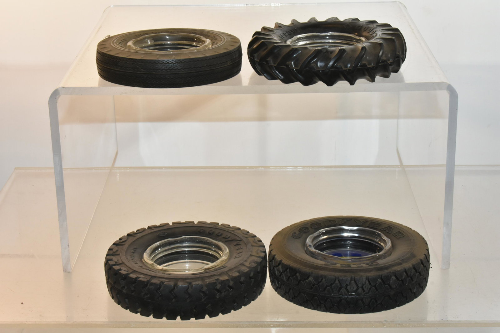 Vintage Goodyear Ashtrays: Lot includes (4) ashtrays including a tractor tire, a big rig tire, and (2) with good blue interior graphics.