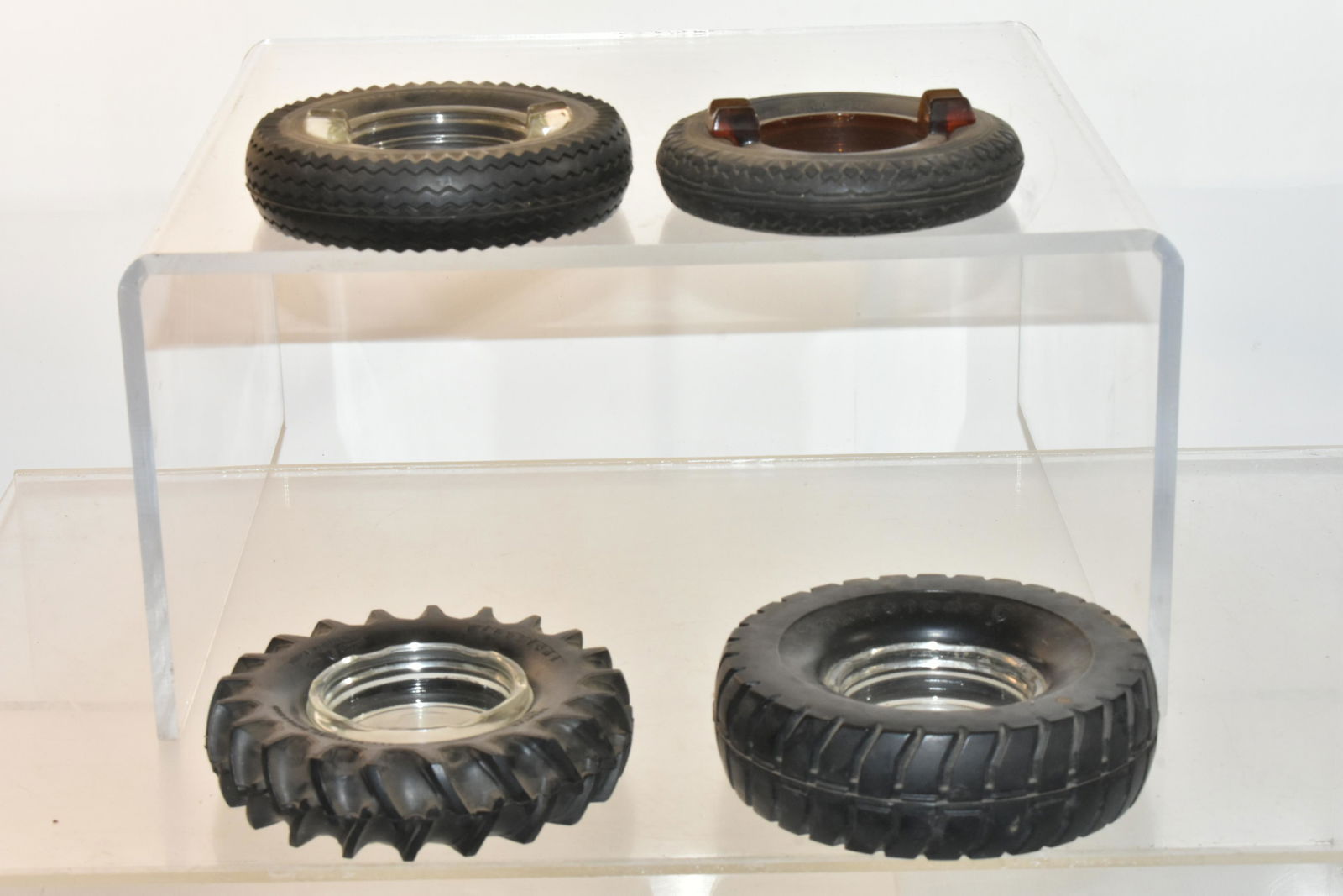 Vintage Firestone Tire Ashtrays: Lot includes a tractor tire, big rig tire with red and white graphics, and (2) with impressed Firestone logo.